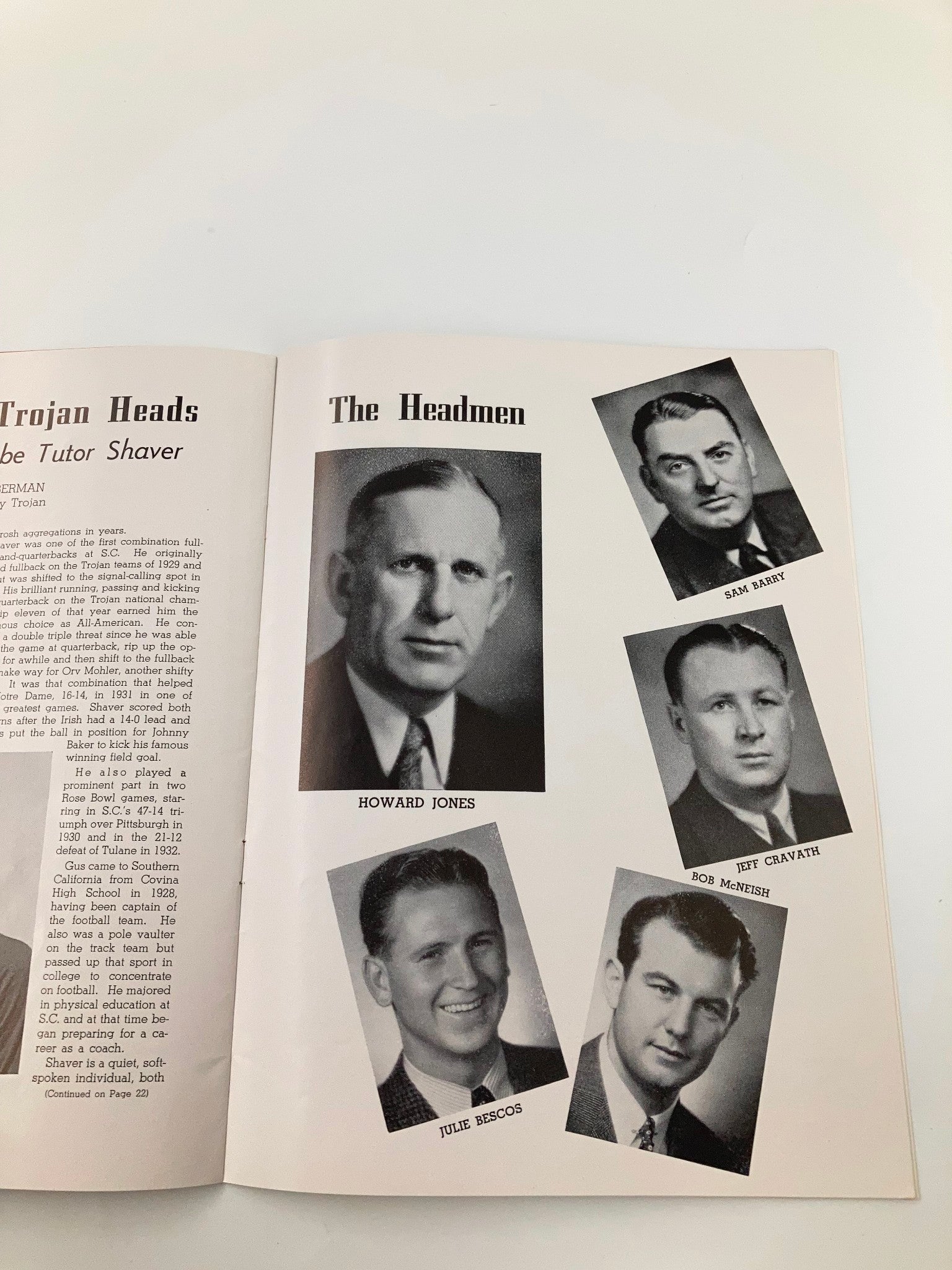 Page from 'The Pigskin Review' featuring headshots of USC Trojans coaching staff including Howard Jones, Sam Barry, Jeff Cravath, and others.