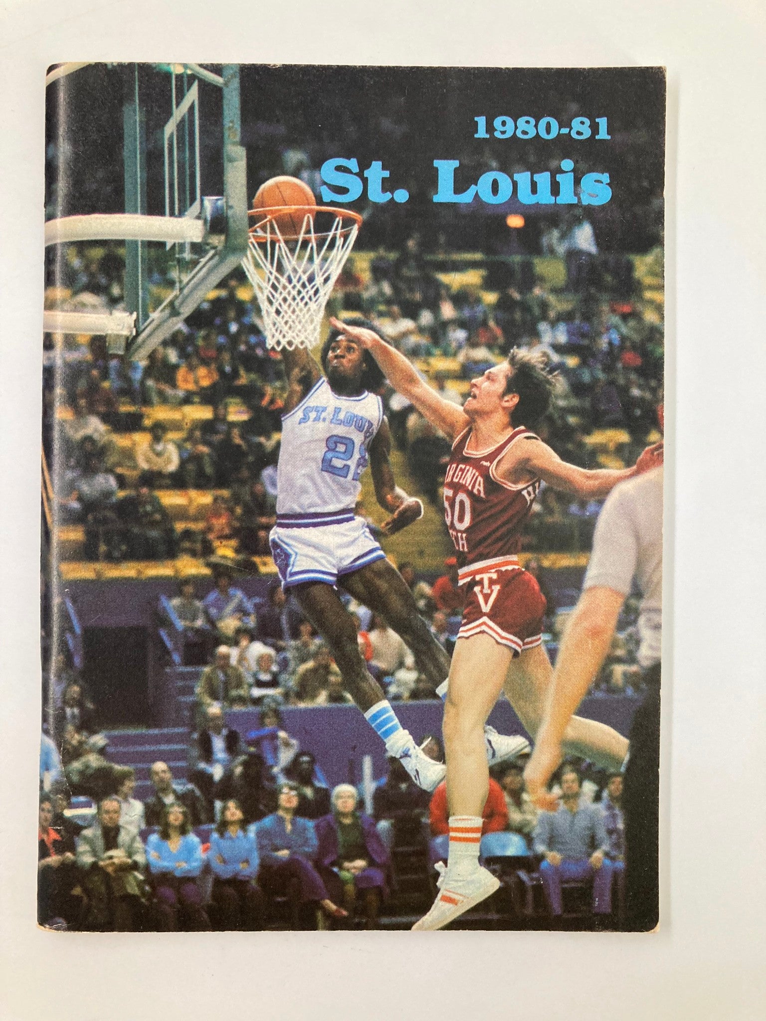 1980-1981 NCAA Saint Louis University Billikens Basketball Press Guide featuring an action shot of a player attempting to score a basket during a game.
