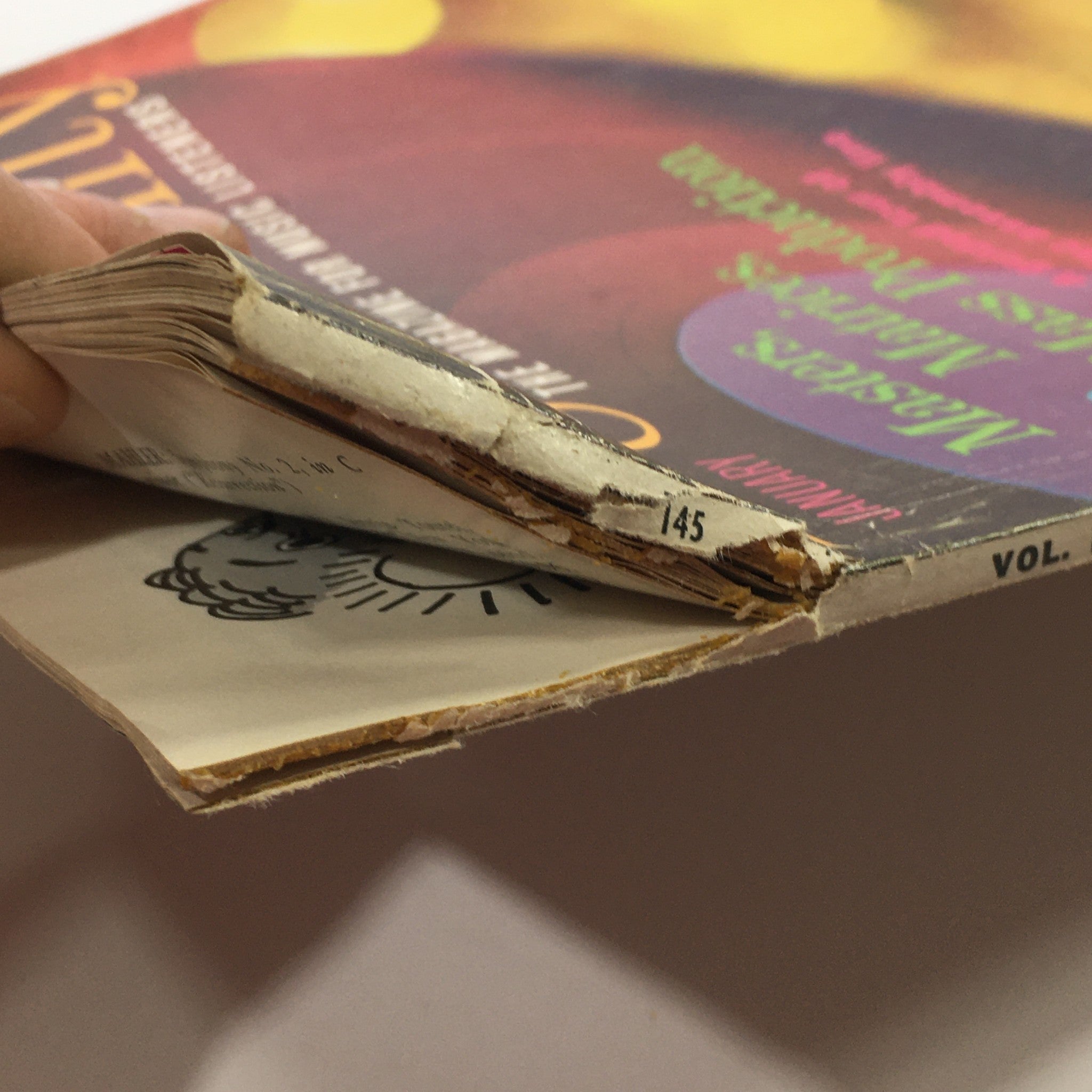 Spine view of the VTG High Fidelity Music Magazine January 1965 showing wear and a vintage aesthetic with a partially visible page edge and magazine volume information.