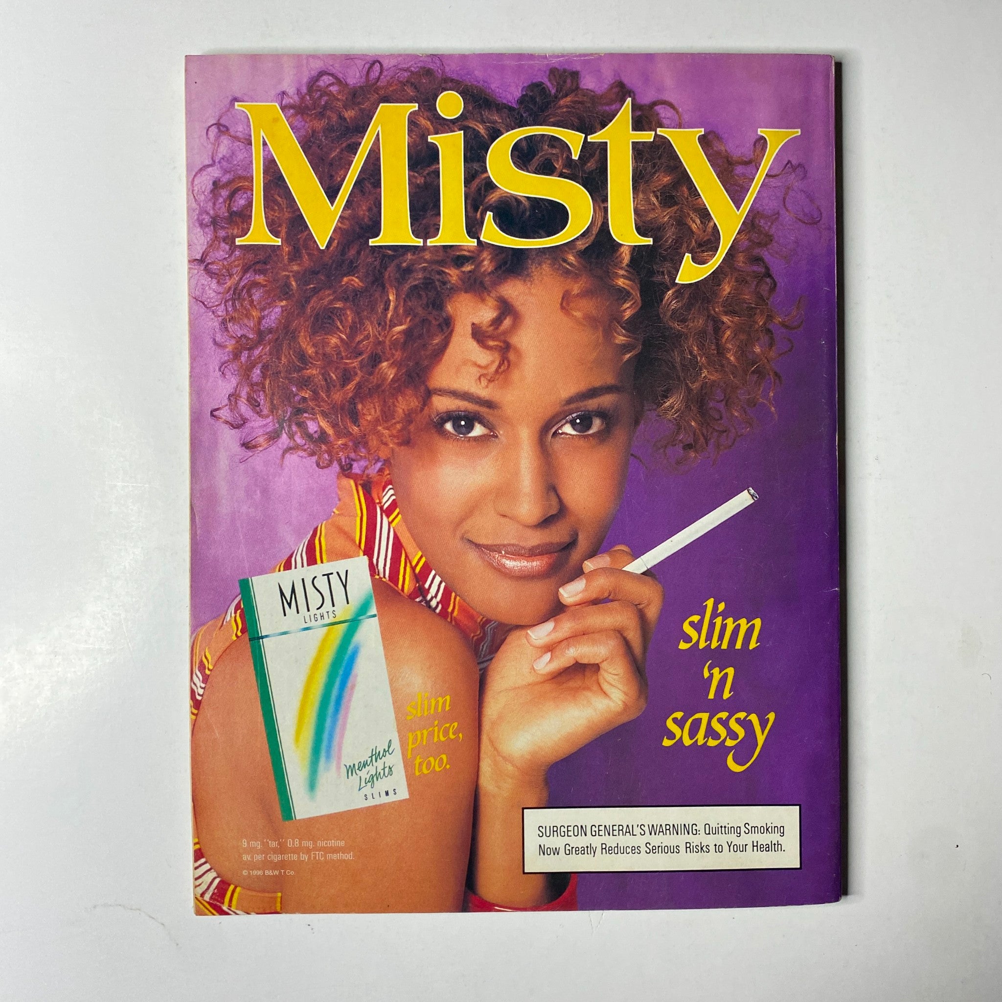 Cover of Misty Magazine featuring a stylish woman with curly hair, showcasing the title 'Misty' along with the tagline 'slim 'n sassy' and a cigarette, highlighting trends and beauty in women’s lifestyle.