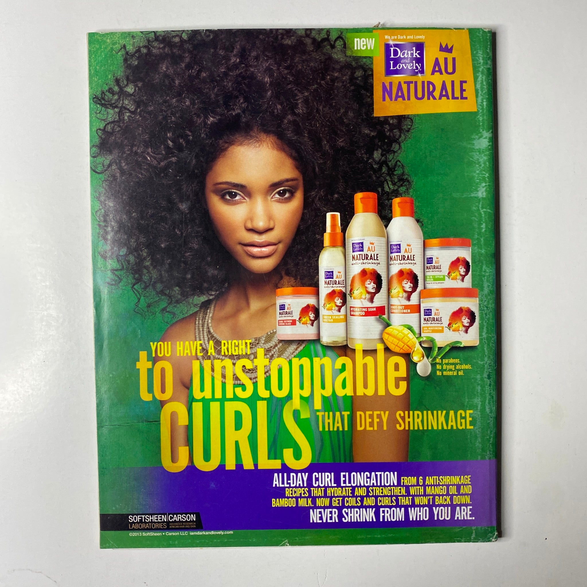 Back cover of Ebony Magazine April 2013 Vol. LXVIII, No. 6, showcasing a beauty advertisement for Dark and Lovely hair products, featuring a model with naturally curly hair.