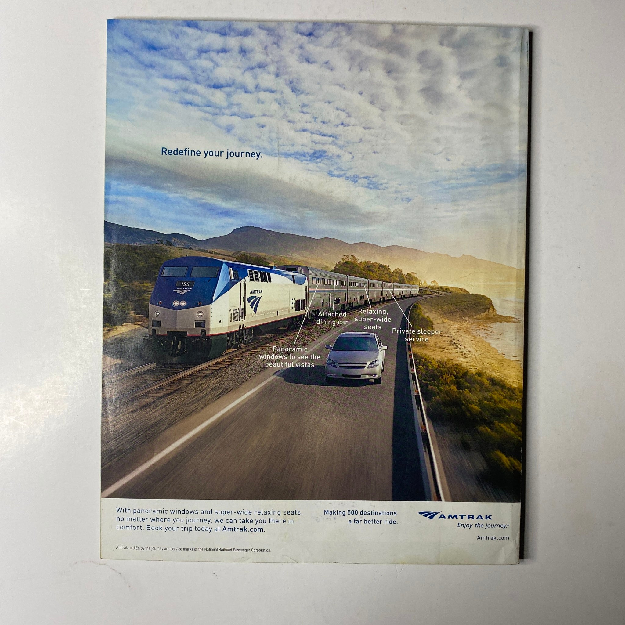 Ebony Magazine June 2014 Vol. LXIX, No. 8 displaying an Amtrak advertisement promoting travel with panoramic windows and super-wide seating, emphasizing comfort and adventure.