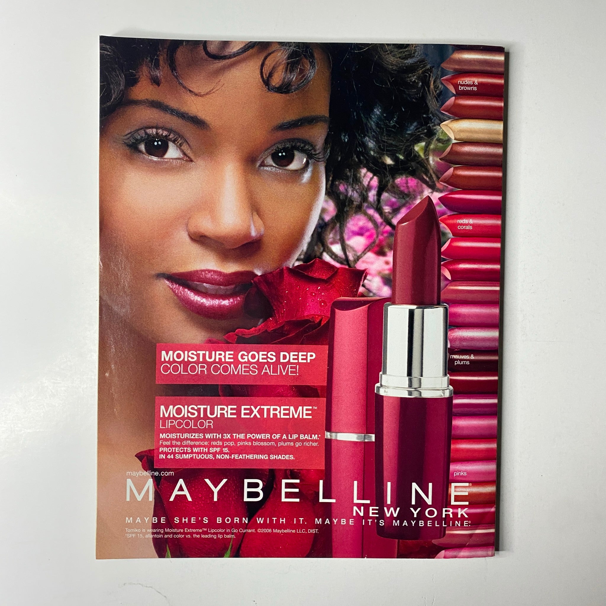 Advertisement for Maybelline in Ebony Magazine July 2006, promoting Moisture Extreme Lipcolor, set against a vibrant background, from the issue that features LL Cool J on the cover.