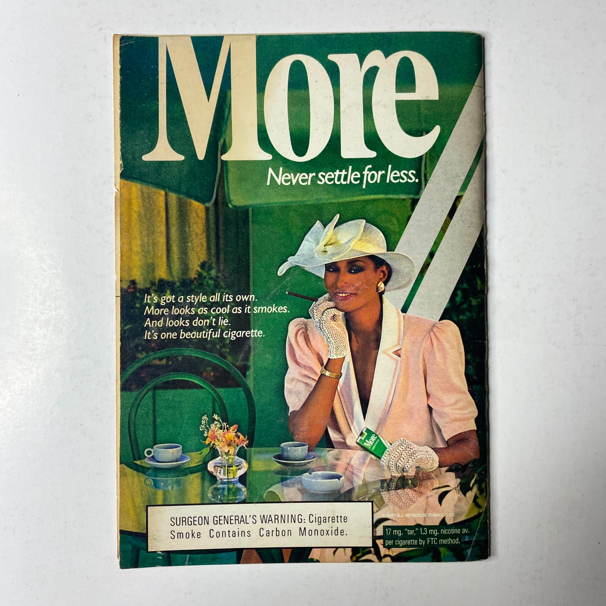 Cover of More Magazine featuring a woman in a white hat and elegant attire enjoying a coffee setting. The phrase 'More Never settle for less' is prominently displayed. This image is part of Jet Magazine March 21, 1988 Vol. 73, No. 25.