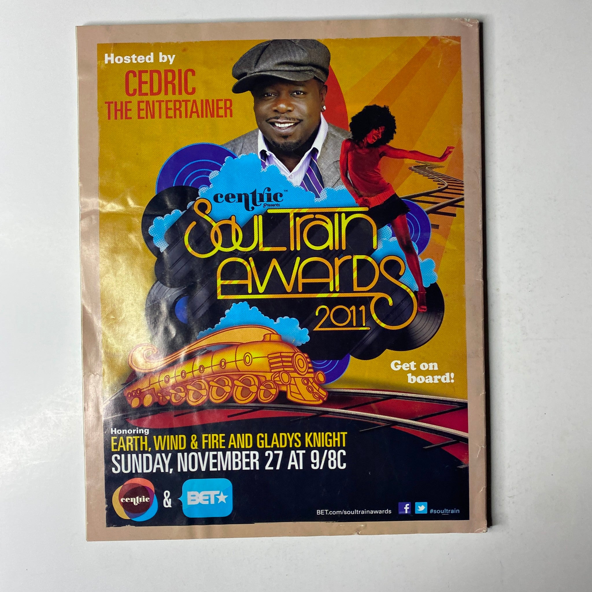 Promotional poster for the 2011 Soultrain Awards hosted by Cedric the Entertainer. Celebrating Earth, Wind & Fire and Gladys Knight, the event emphasizes the contributions of iconic artists to entertainment. Ebony Magazine – December 2011 – Vol. 67, No. 2 – Jennifer Hudson Cover.