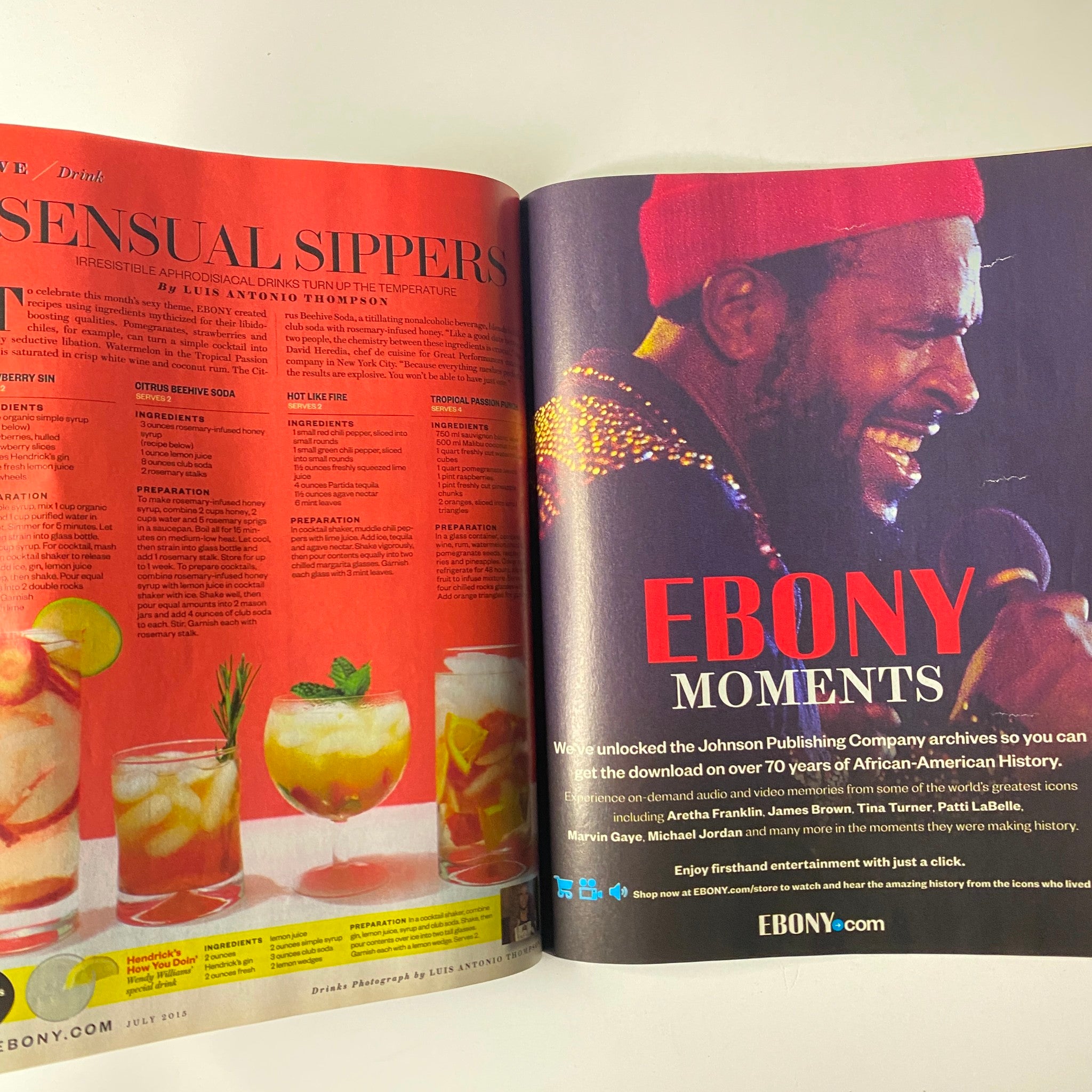 Page spread from Ebony Magazine July 2015 Vol 70 No. 9 featuring 'Sensual Sippers' cocktail recipes and a section titled 'Ebony Moments' highlighting iconic African-American figures.
