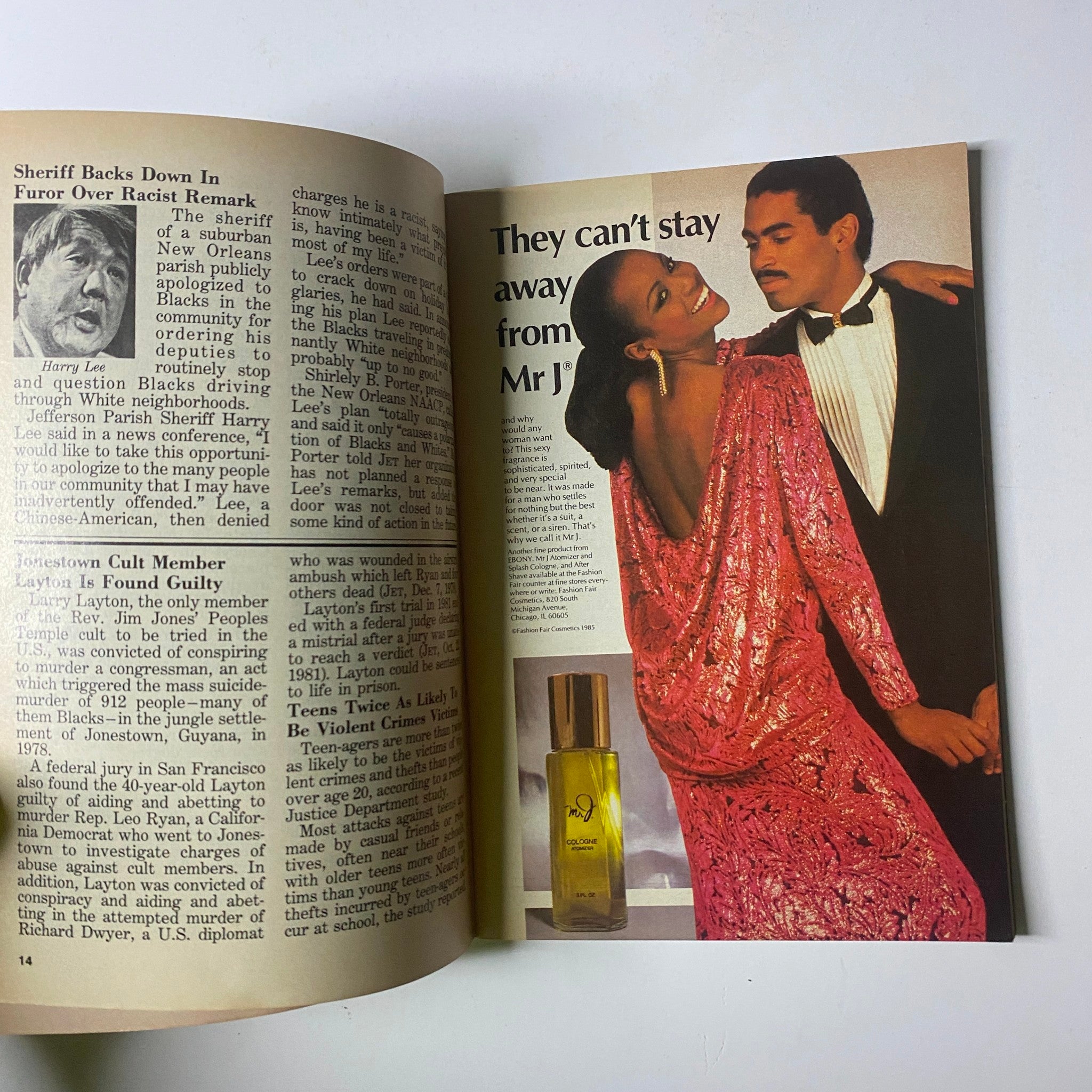 A stunning advertisement in Jet Magazine, December 22, 1986, showcasing a glamorous couple, with the male figure in a tuxedo and the female in a sparkling gown, promoting a luxurious perfume, Volume 71, No. 14.