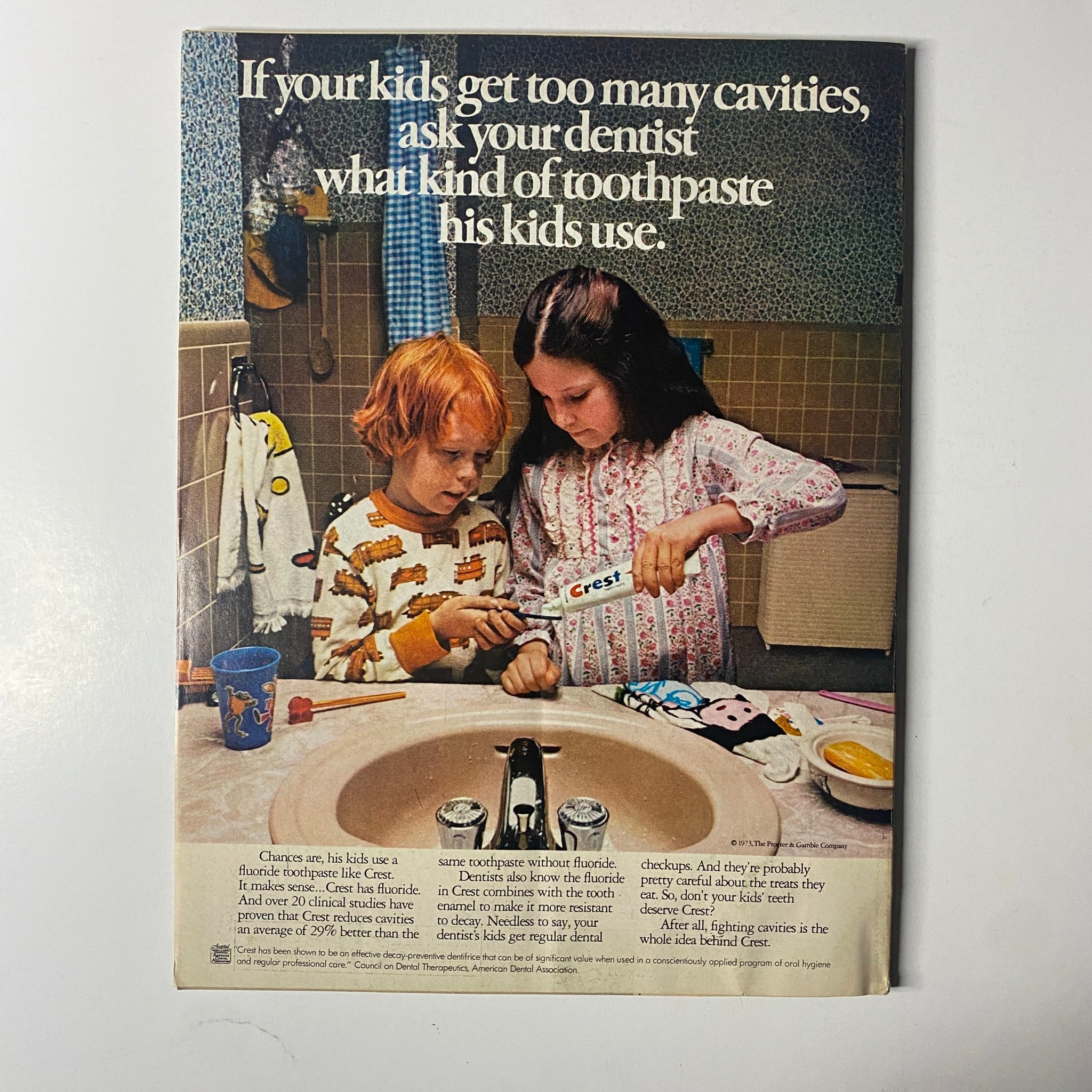 Advertisement page from McCall’s Magazine January 1974 showing children discussing dental care while using Crest toothpaste, highlighting family health themes.