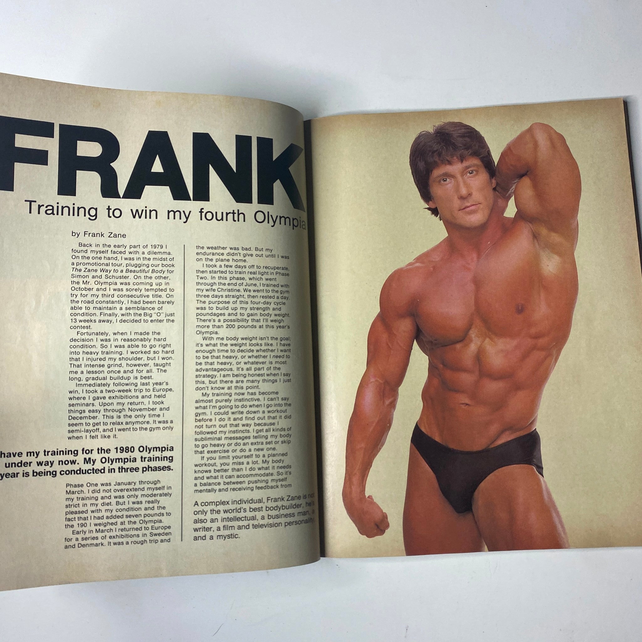 Frank Zane featured in Joe Weider’s Muscle & Fitness Magazine August 1980, showcasing his bodybuilding physique and training regimen for the 1990 Olympia, emphasizing his dedication to fitness and excellence.