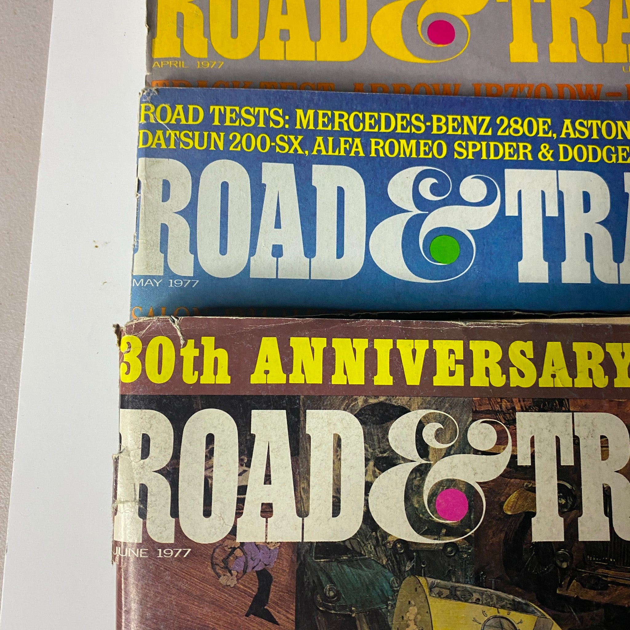 Lot of 24 Road & Track Magazine 1976 - 1979, showcasing issues from April, May, and June 1977, featuring automotive reviews and road tests.