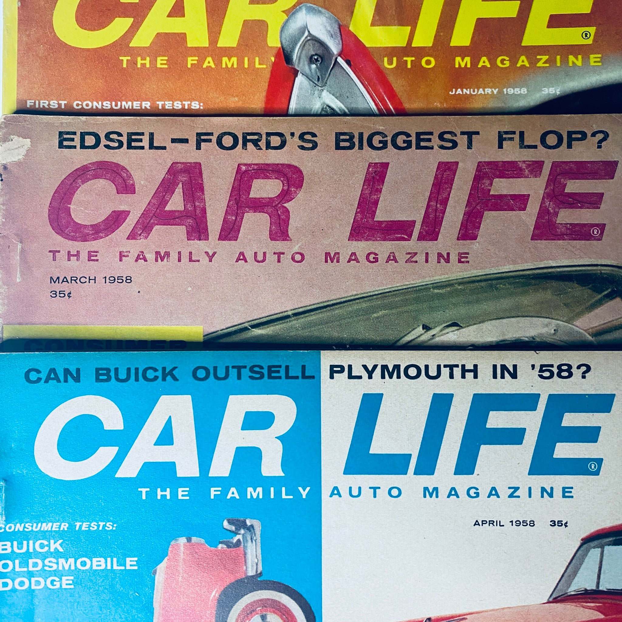 Close-up view of three issues from Car Life The Family Auto Magazine, highlighting January, March, and April 1958 editions with striking headlines and vintage auto imagery.