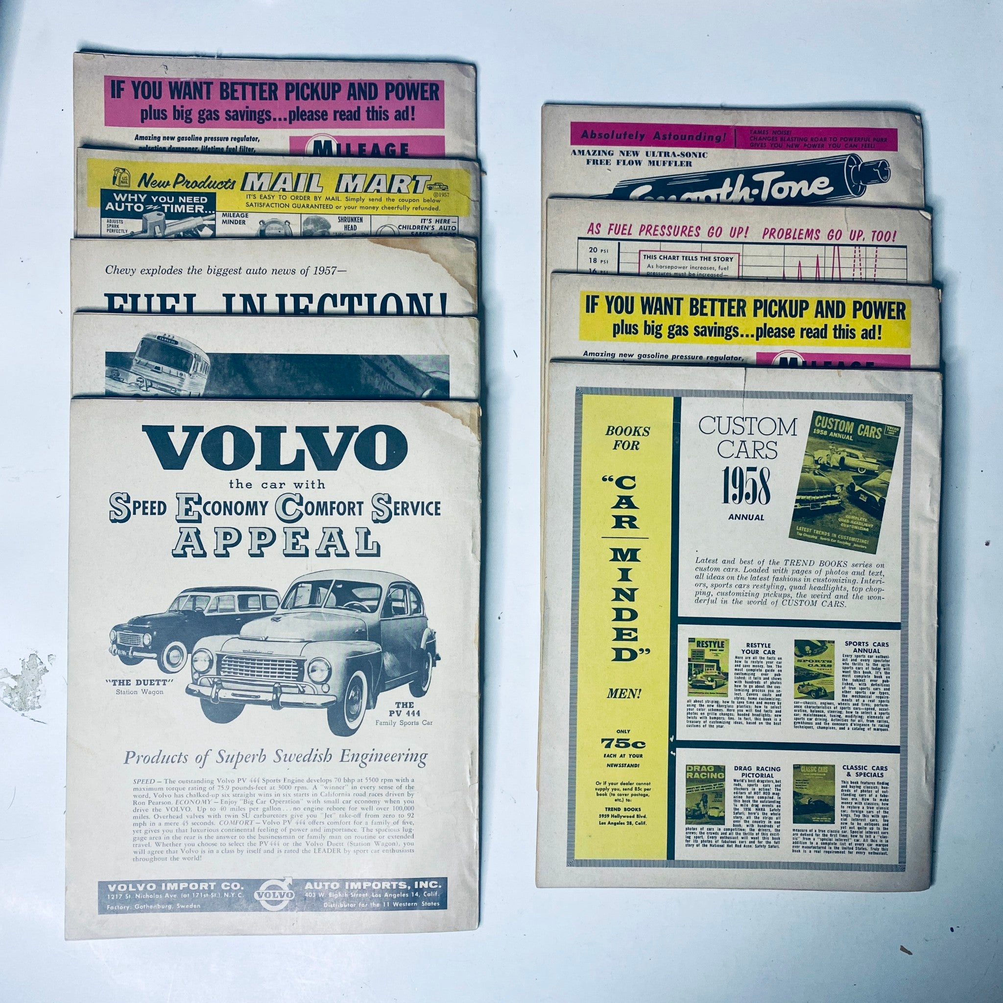 Collection of advertisements and articles from Motor Life Magazine featuring Volvo and custom car services, showcasing vintage automotive promotions and industry insights.
