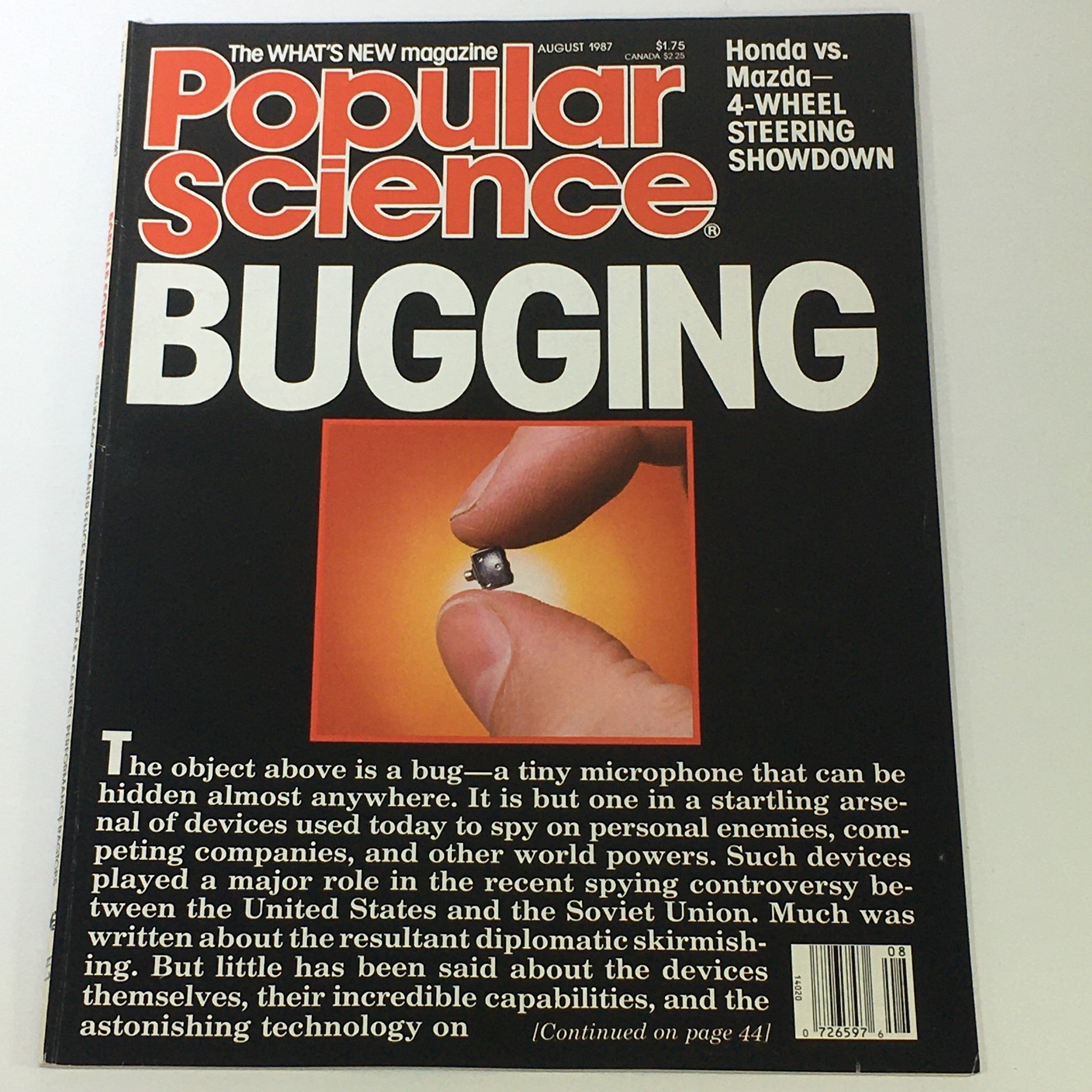 Cover of VTG Popular Science Magazine August 1987 featuring article on bugging technology and a comparison of 4-wheel steering systems, highlighting a tiny microphone held by a hand.