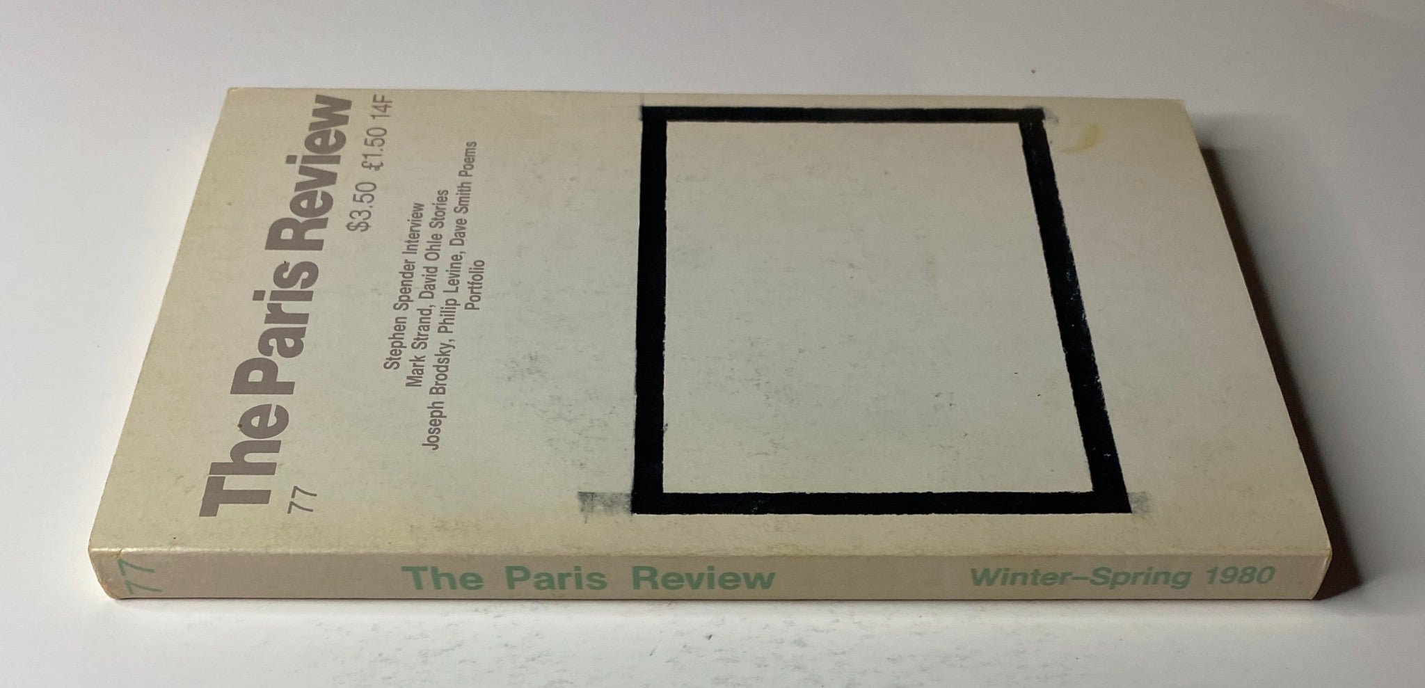 Side view of The Paris Review Magazine Winter-Spring 1980 No. 77 showcasing its spine with the title and issue number, emphasizing its collection of fiction, poetry, and interviews.