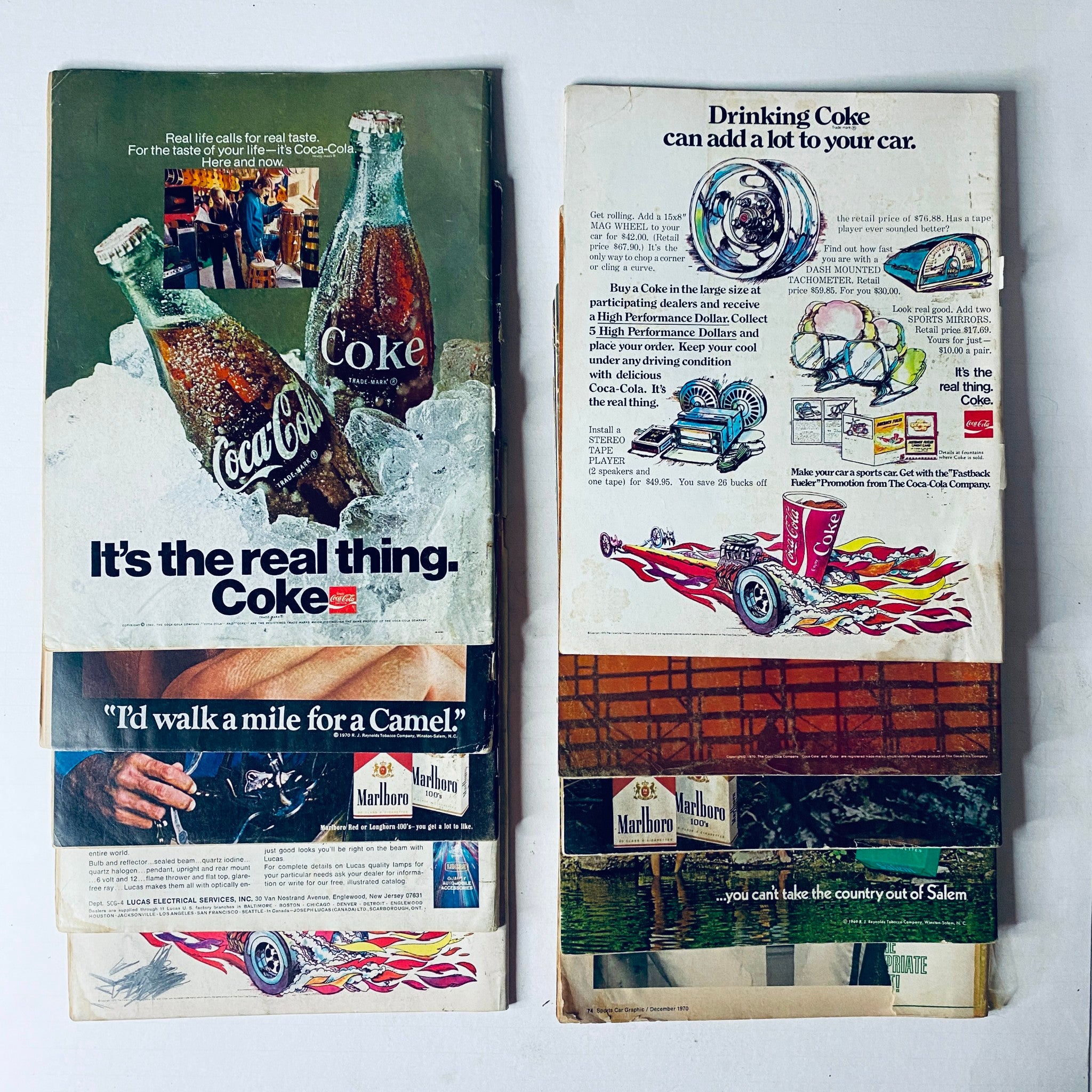 Back covers of vintage magazines showing retro advertisements for Coca-Cola and Marlboro, associated with the era of Sports Car Graphic magazines. Lot of 10 Sports Car Graphic Magazine 1970 January - April, July - December.