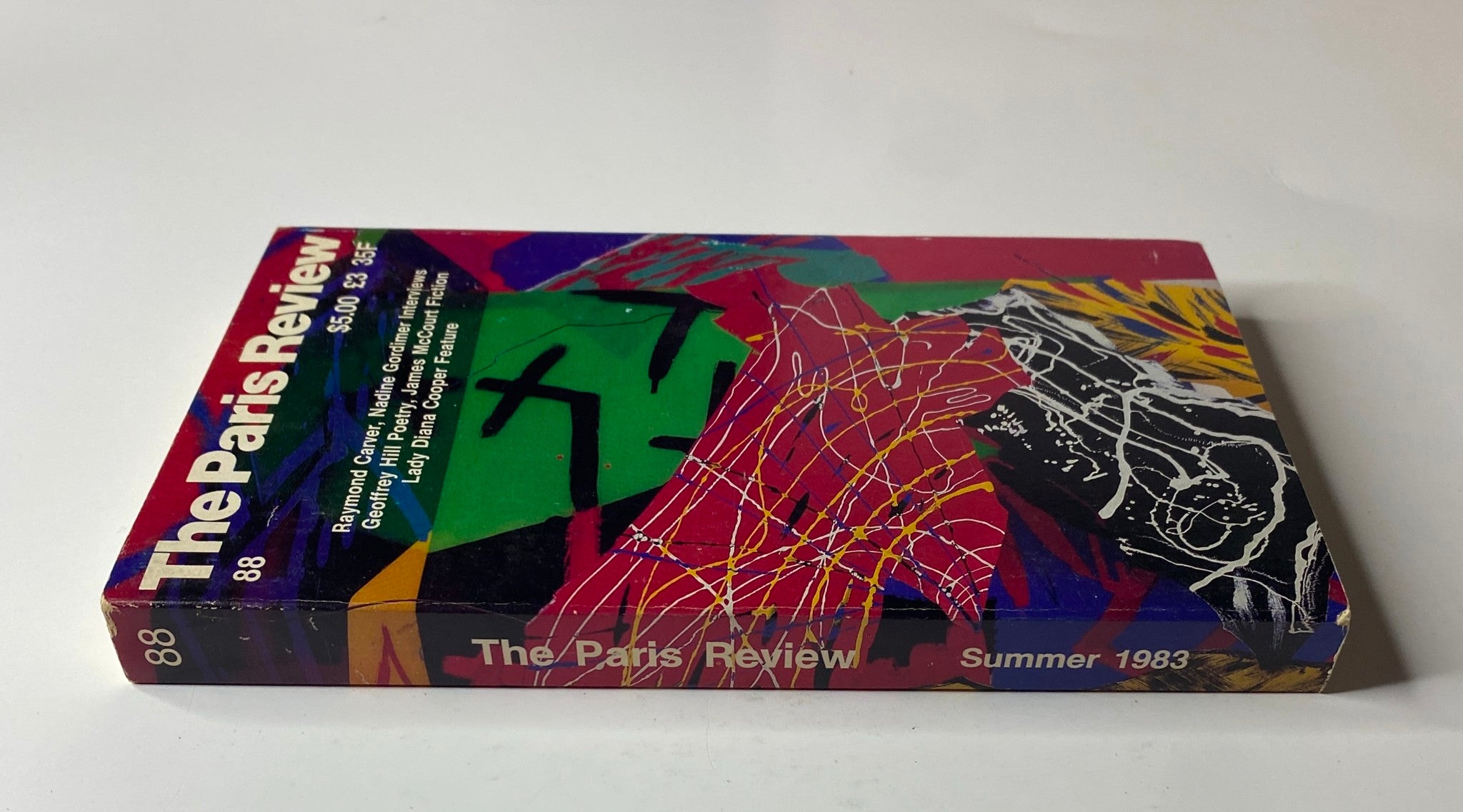 Spine view of The Paris Review Magazine Summer 1983 No. 88 Raymond Carver showcasing the title and vibrant cover design.