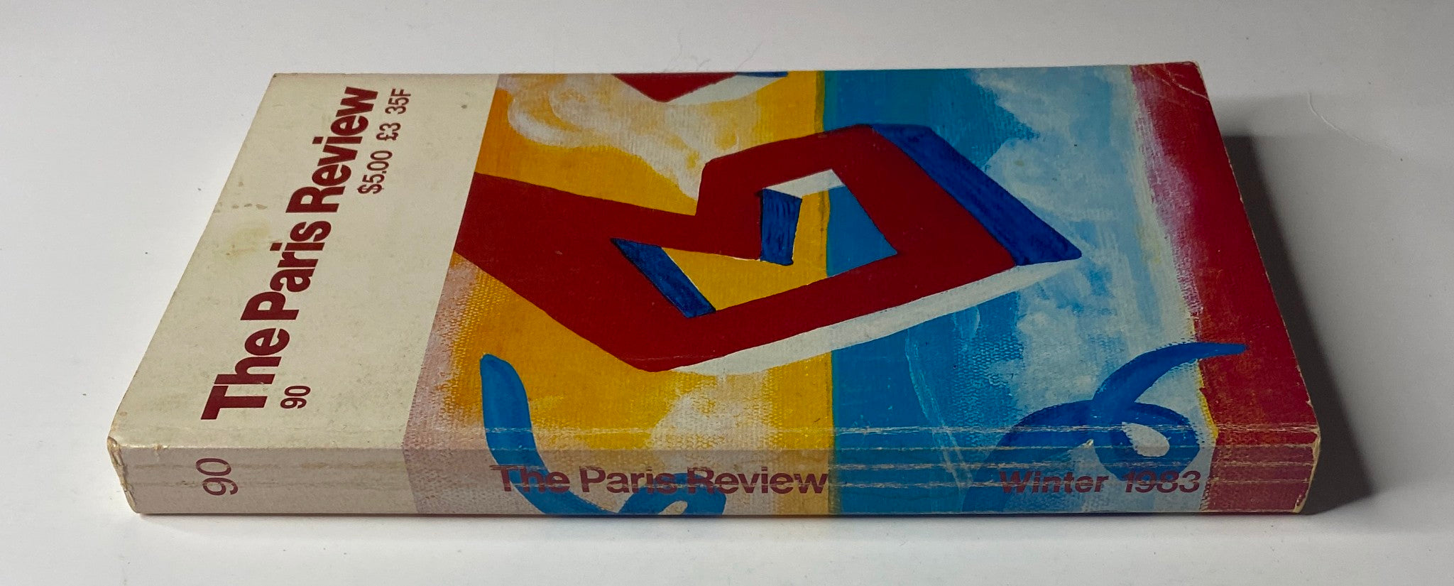 Side view of The Paris Review Magazine Winter 1983 No. 90 showcasing the spine and design elements.
