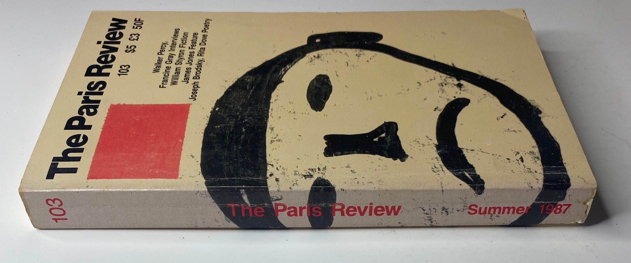 Spine view of The Paris Review Magazine Summer 1987 No. 103, showcasing its title and issue number along with featured content.