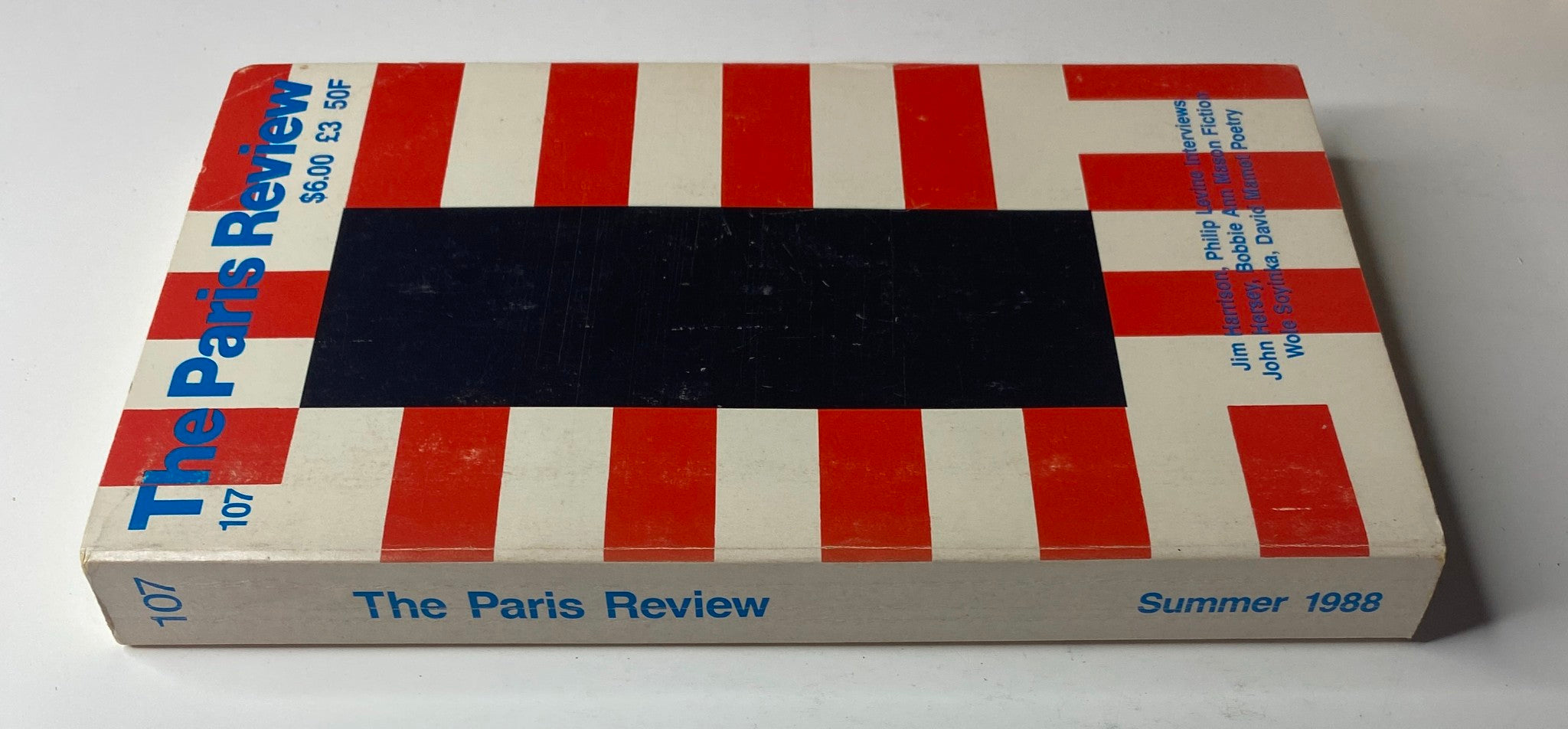 Cover of The Paris Review Magazine Summer 1988 No. 107 featuring bold red and white striped design and minimalistic text.