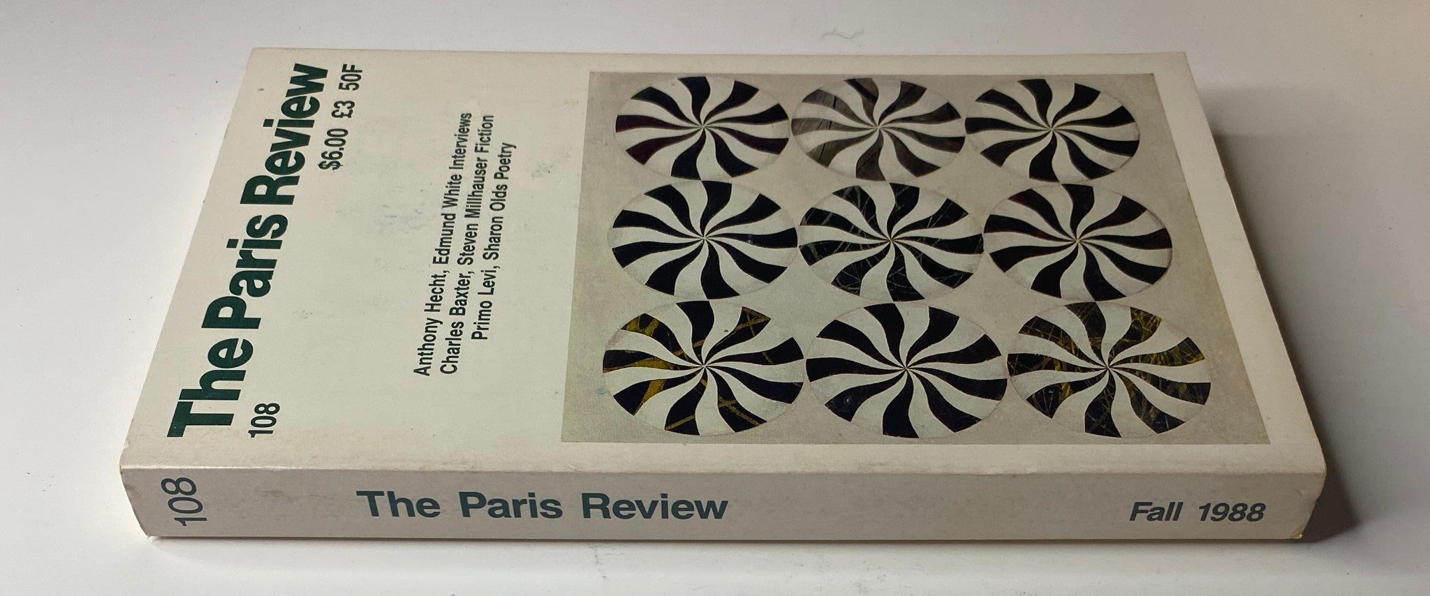 Side view of The Paris Review Magazine Fall 1988 No. 108, displaying the issue number and information about featured interviews and fiction, emphasizing the literary content inside.