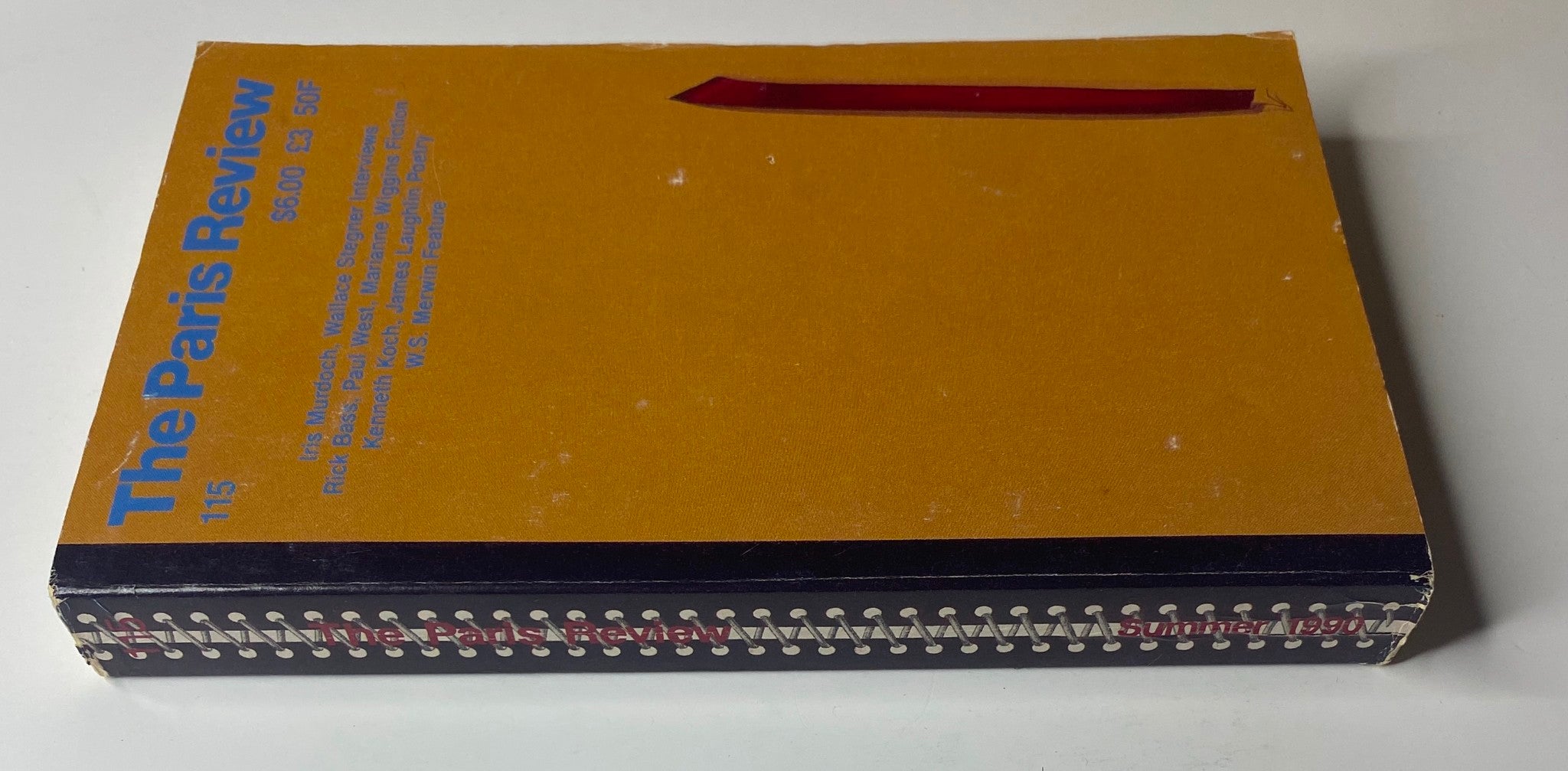 Side view of The Paris Review Magazine Summer 1990 No. 115, displaying its spine and unique cover design, highlighting its literary features and artistic presentation.