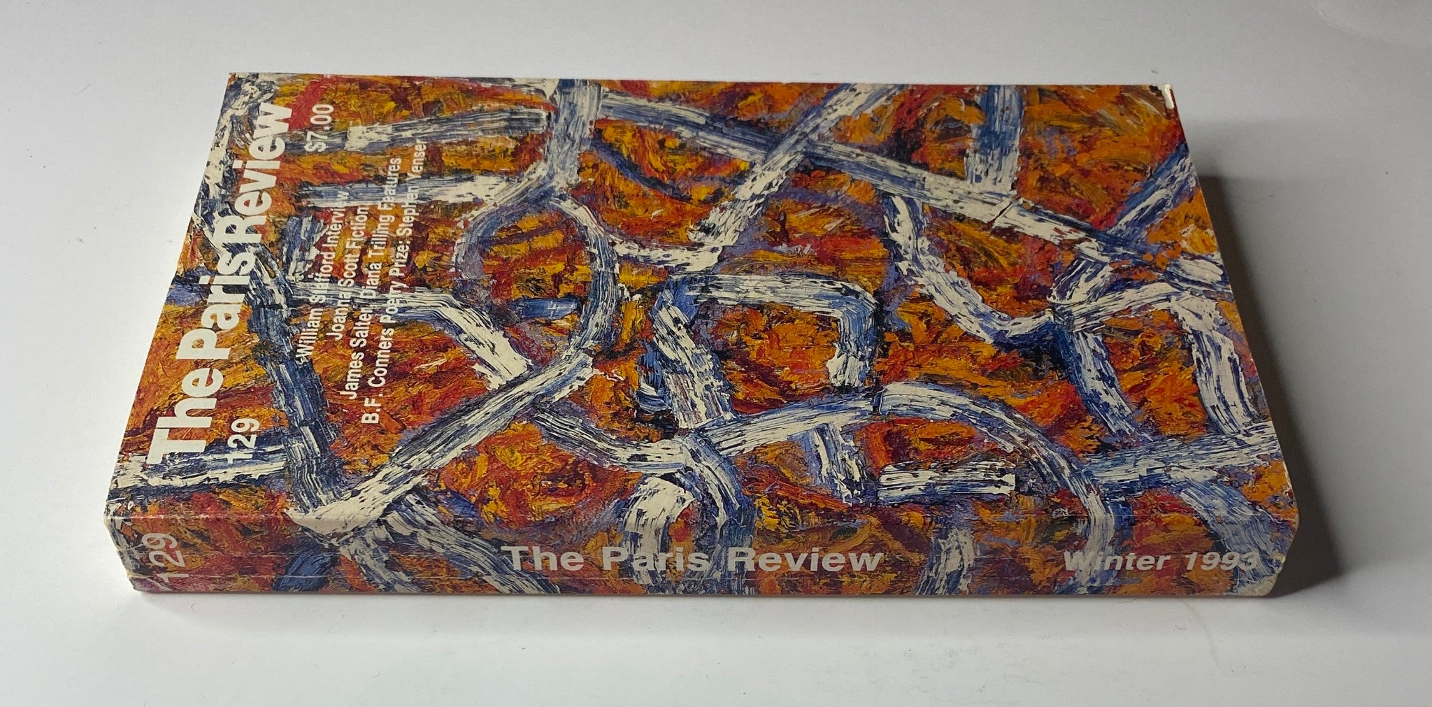 Another angle of The Paris Review Magazine Winter 1993 No. 129, showcasing its spine and distinctive abstract cover design.