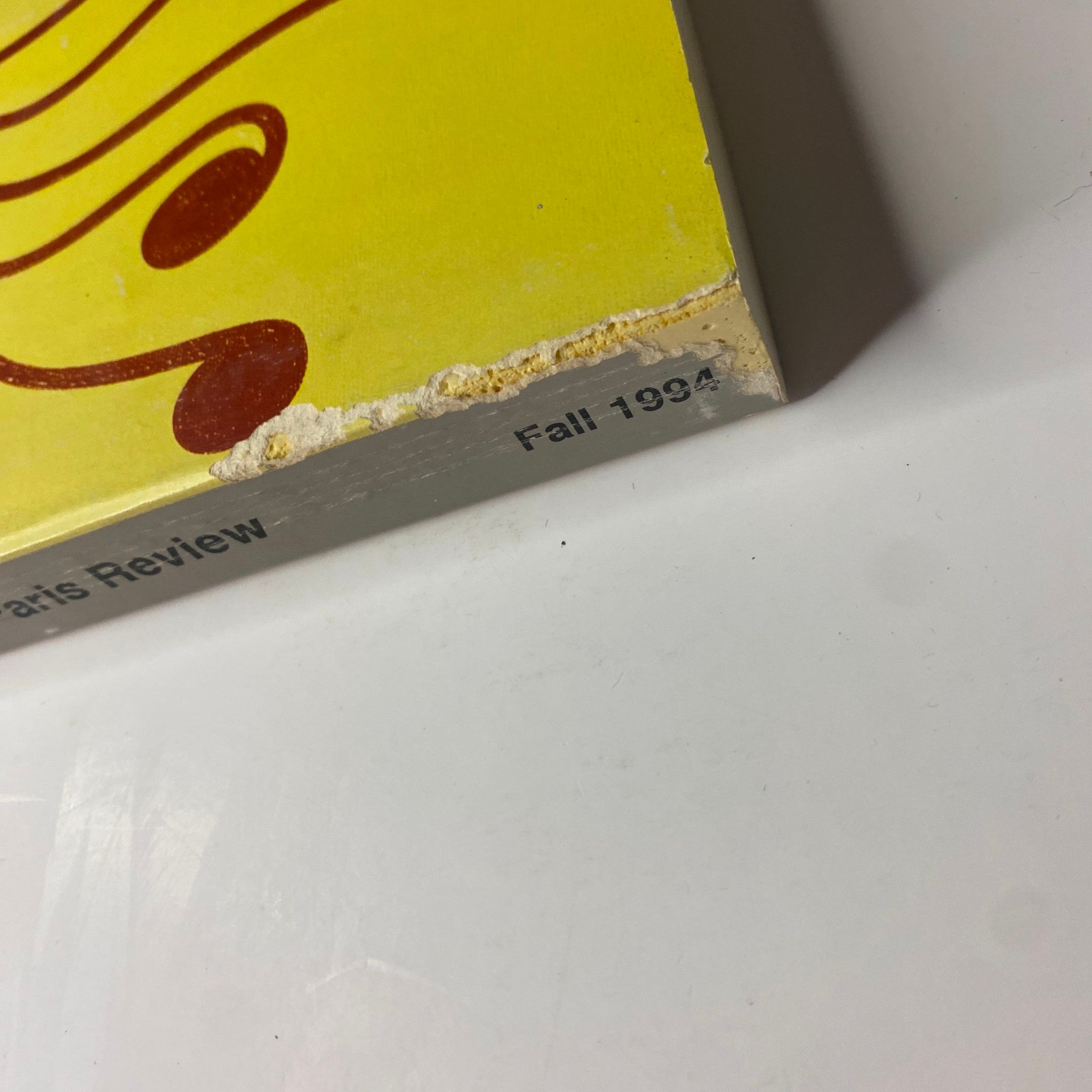 Close-up of the edge of The Paris Review Magazine Fall 1994 No. 132 showing minor wear details and the printed year 'Fall 1994' on the cover.
