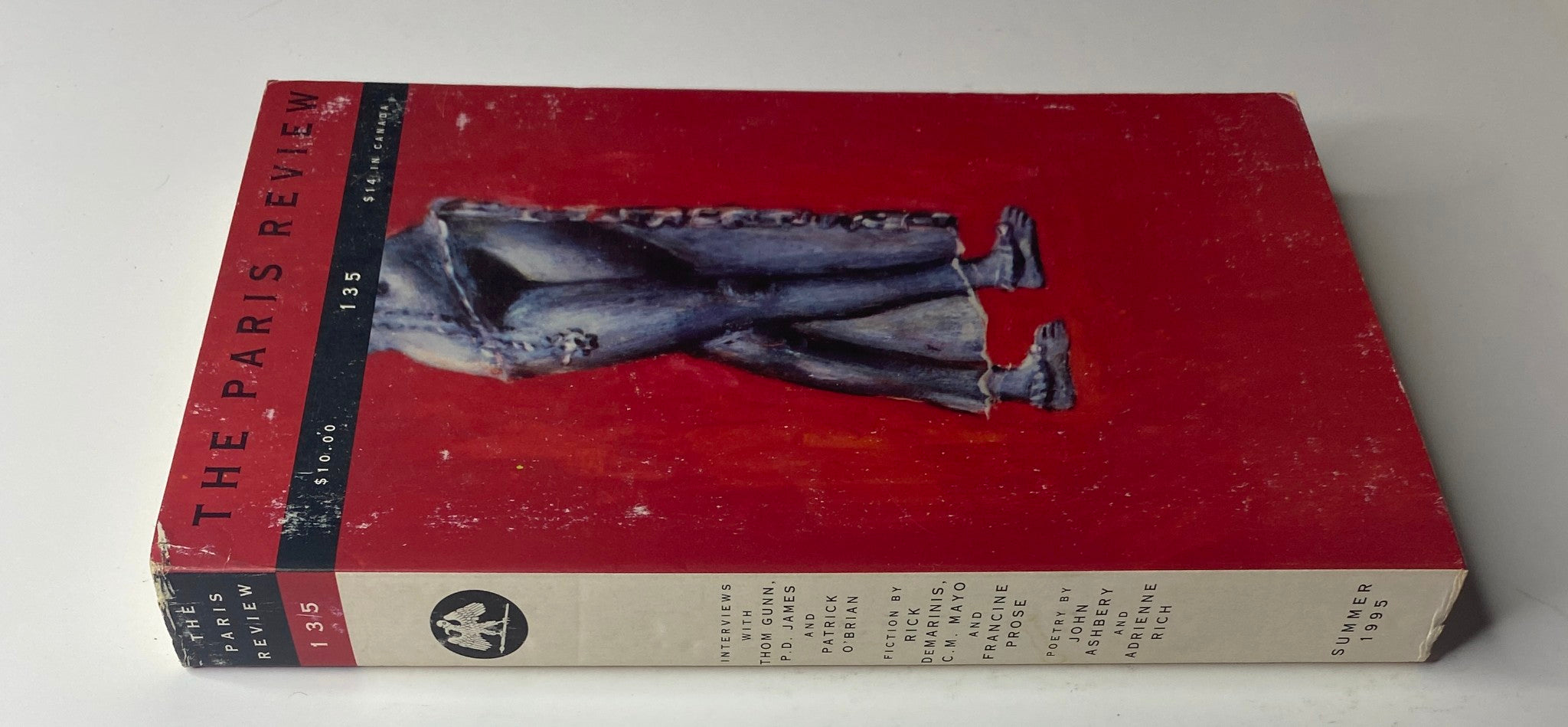 Side view of The Paris Review Magazine Summer 1995 No. 135 showing the spine and continuation of the artwork on the cover, highlighting its artistic design and literary content.