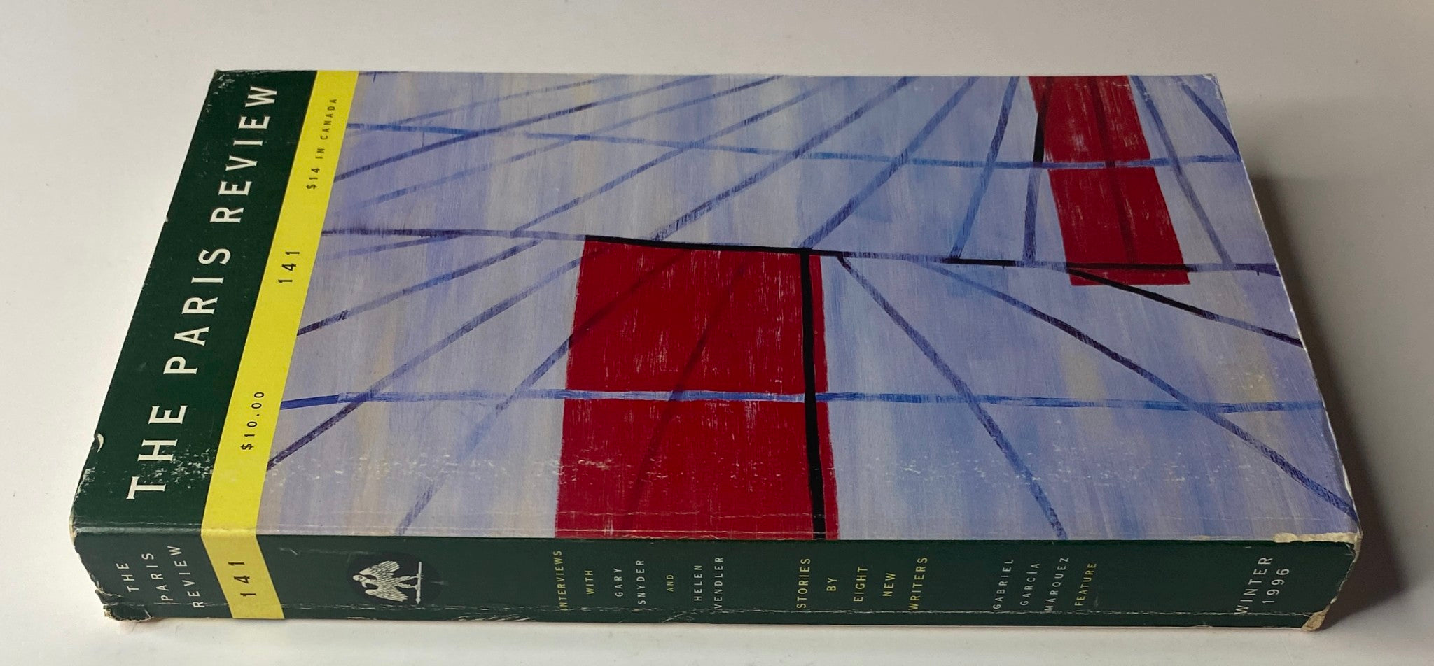 Side view of The Paris Review Magazine Winter 1996 No. 141 displaying the spine and abstract cover design with bright colors.