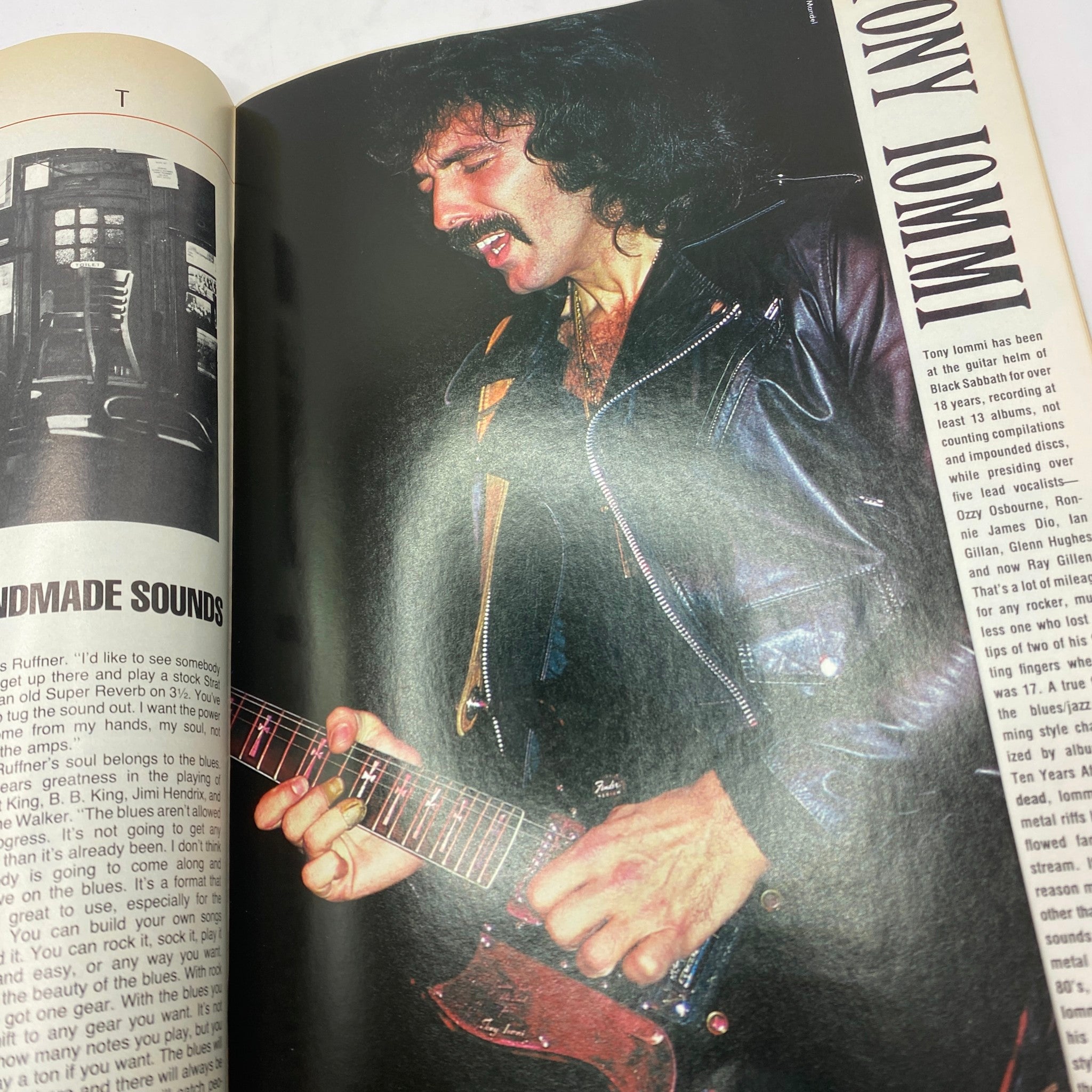 Interior page of VTG Guitar Magazine August 1986 featuring an article on Tony Iommi with a photo of him playing guitar, reflecting the heavy metal scene.