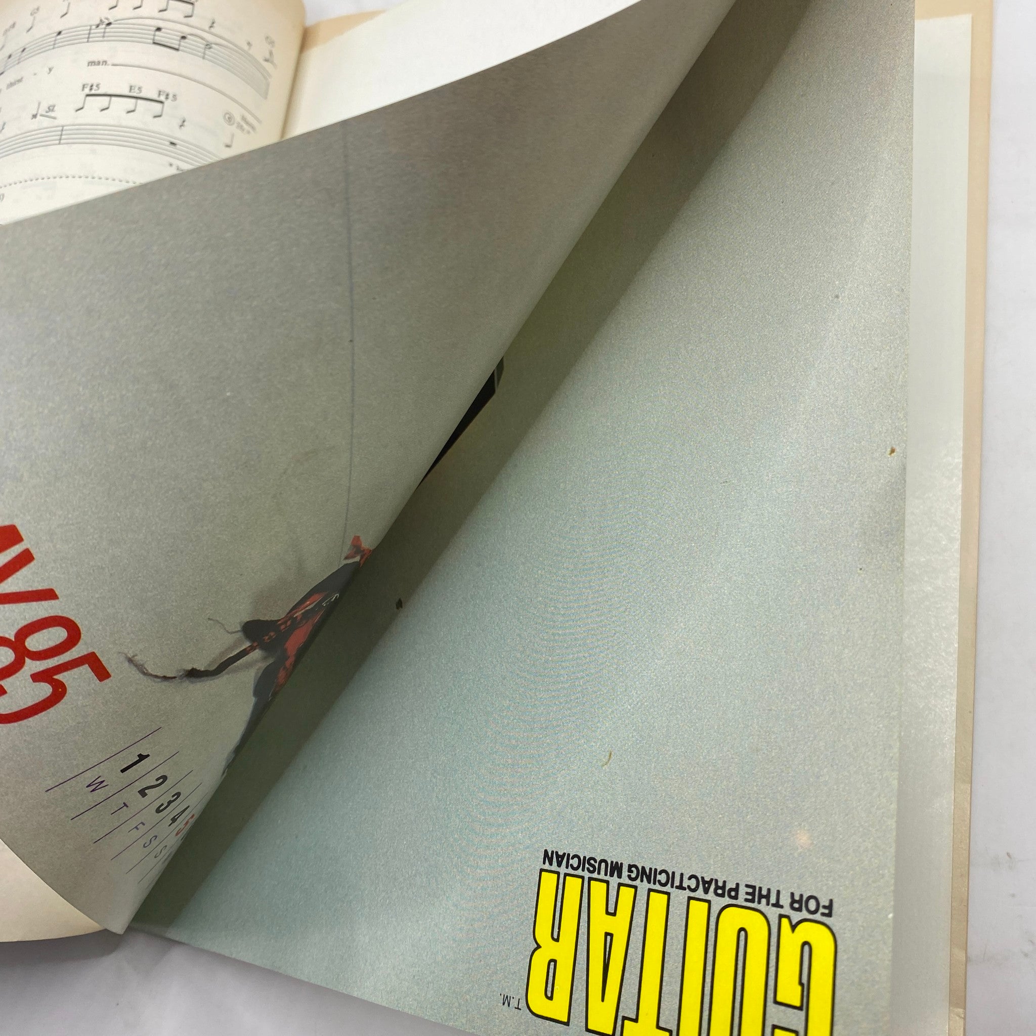 Inside pages of the Vintage Guitar Magazine May 1985 flipping to sheet music sections.