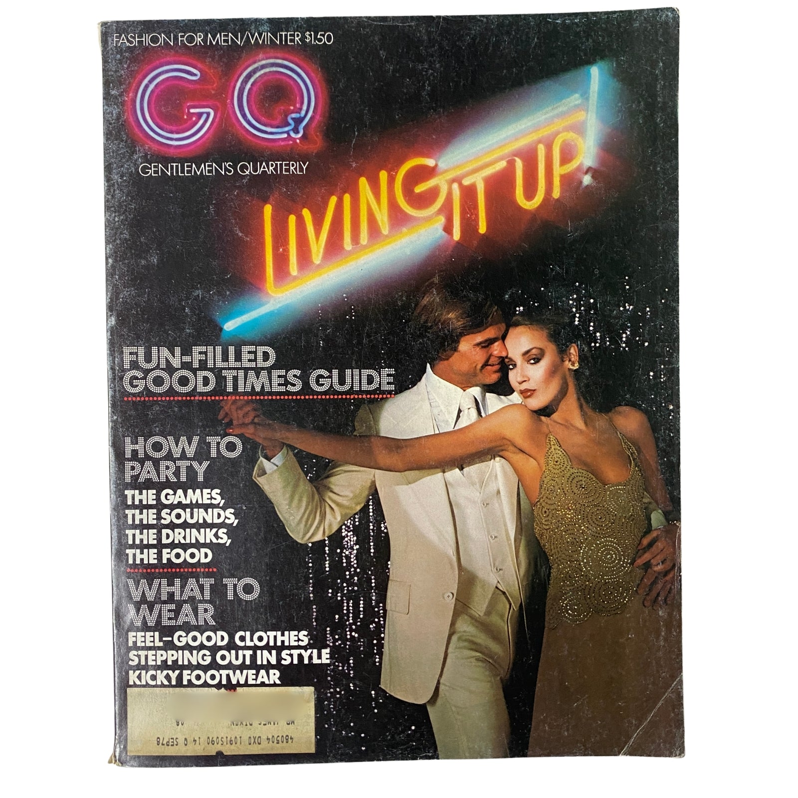 GQ Magazine Winter 1975-1976 Jerry Hall and Joe MacDonald Cover featuring a glamorous couple dressed for evening wear, emphasizing disco-era style and lifestyle.