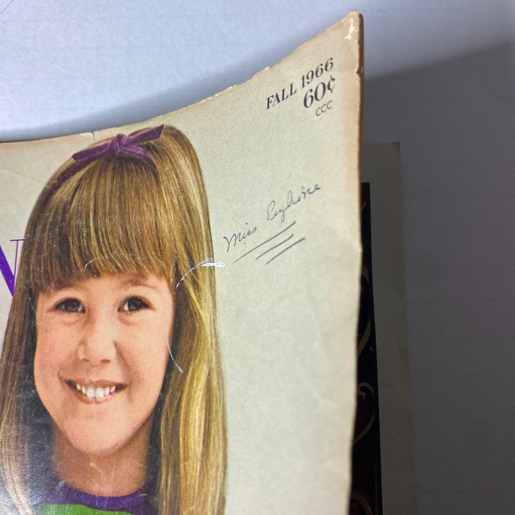 Cover page of the 1966 Vogue Children Fall Catalog featuring a young girl with a smile and hairstyle, showcasing vintage fashion aesthetics.
