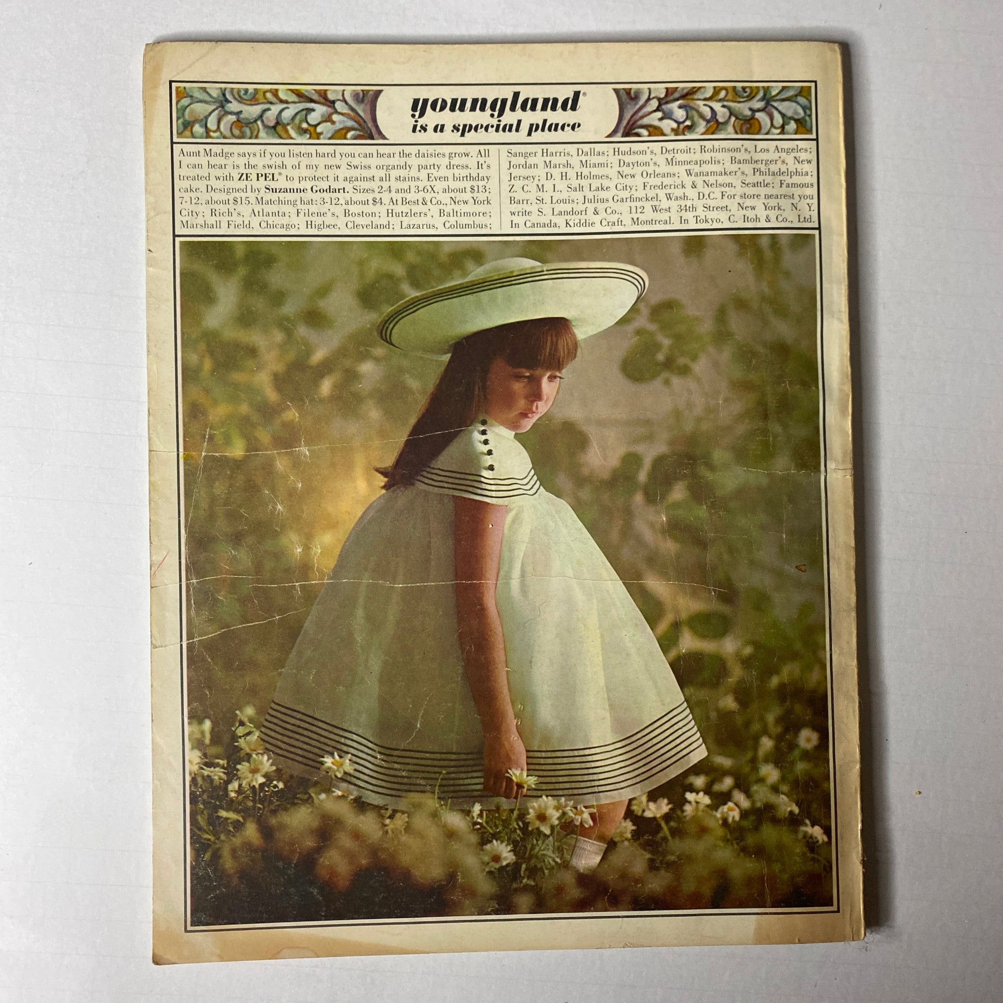 1966 Vogue Children Spring and Summer Catalog presenting a young girl in a classic striped dress with a wide-brimmed hat, capturing the essence of children's fashion from the 1960s.