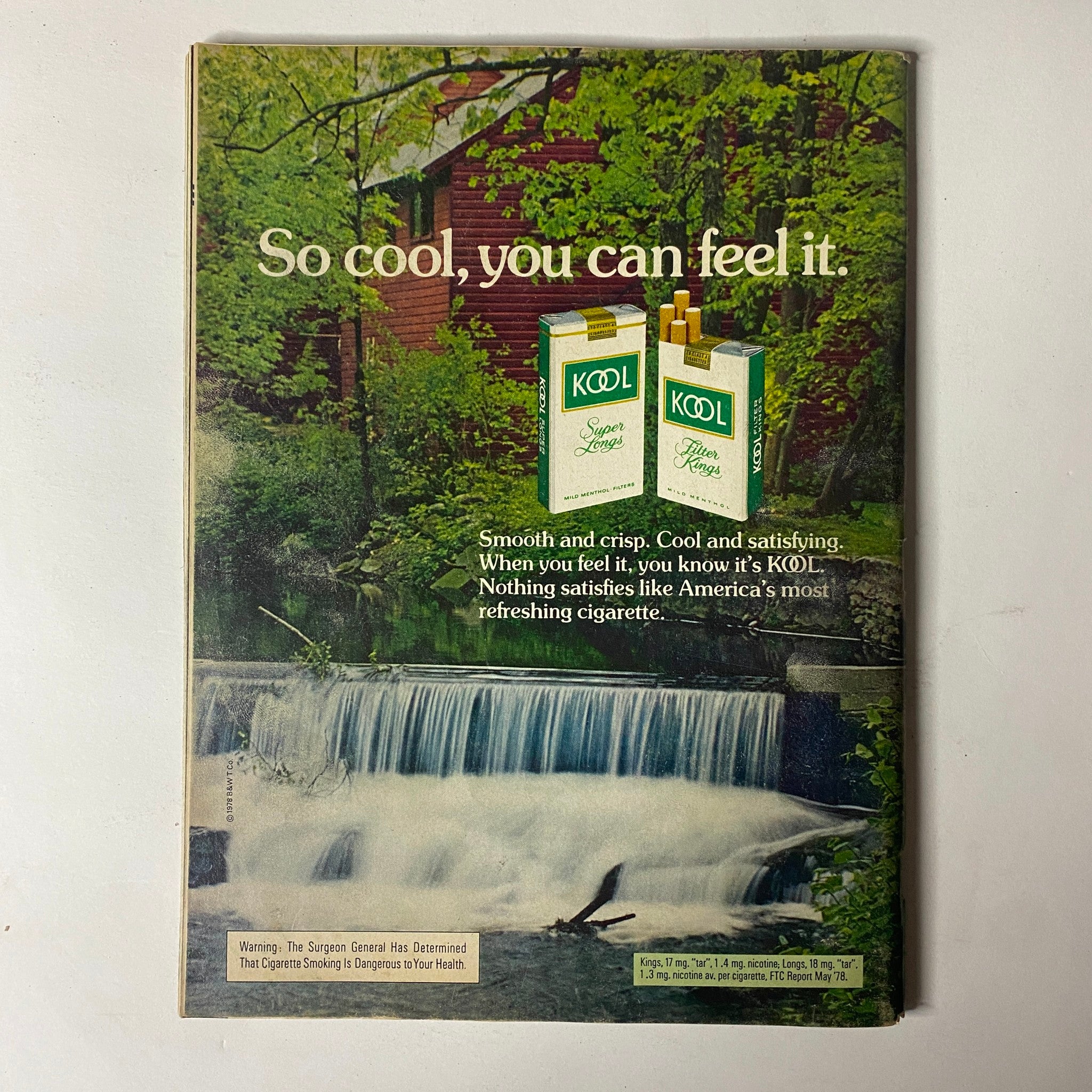 Vintage advertisement for KOOL cigarettes from Car Craft Magazine May 1979 Vol 27 No. 5, highlighting the product in a natural setting with a serene water flow backdrop.