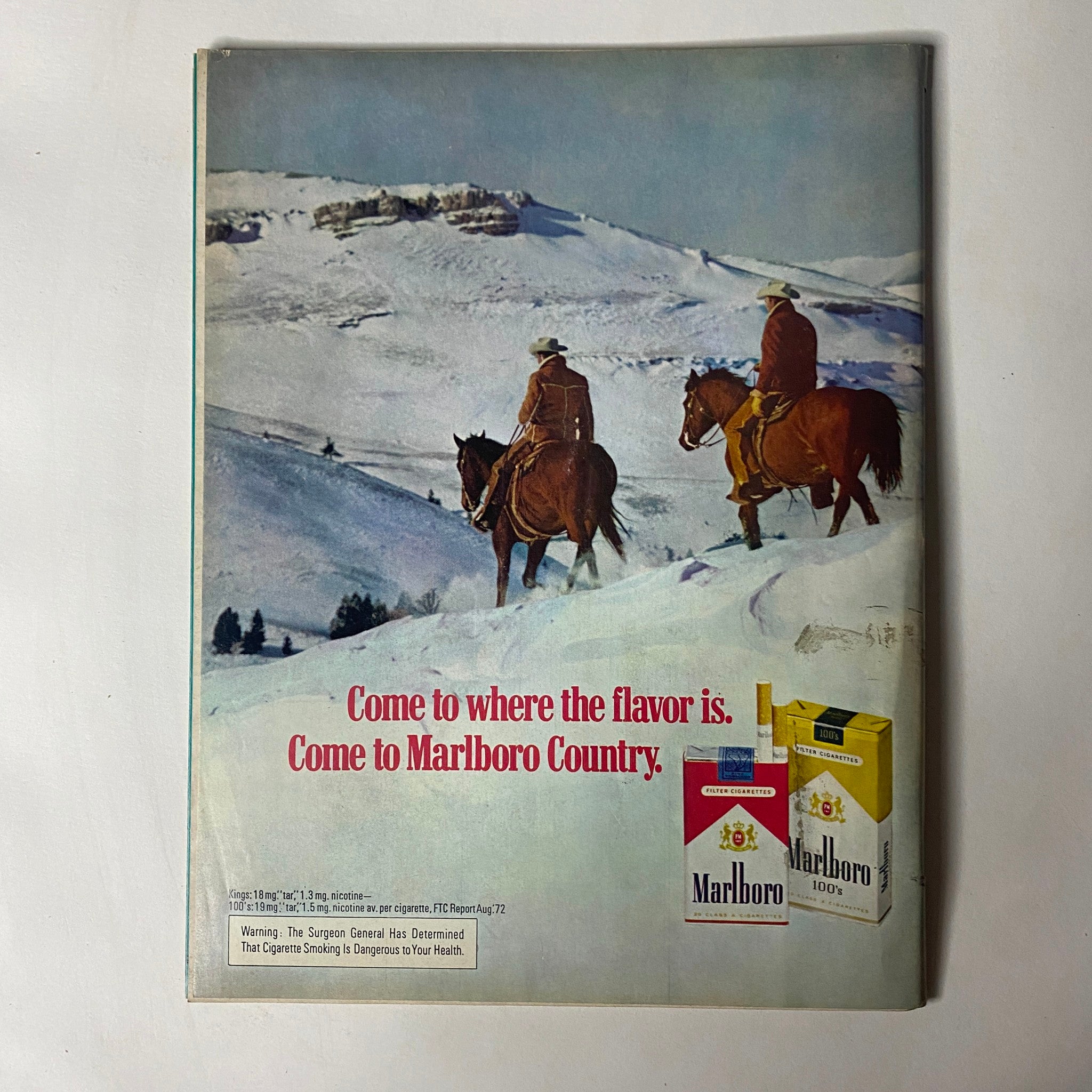 Vintage advertisement featuring cowboys on horseback against a snowy landscape, promoting Marlboro cigarettes with the tagline 'Come to where the flavor is. Come to Marlboro Country.' from the December 1972 issue of Car Craft Magazine.