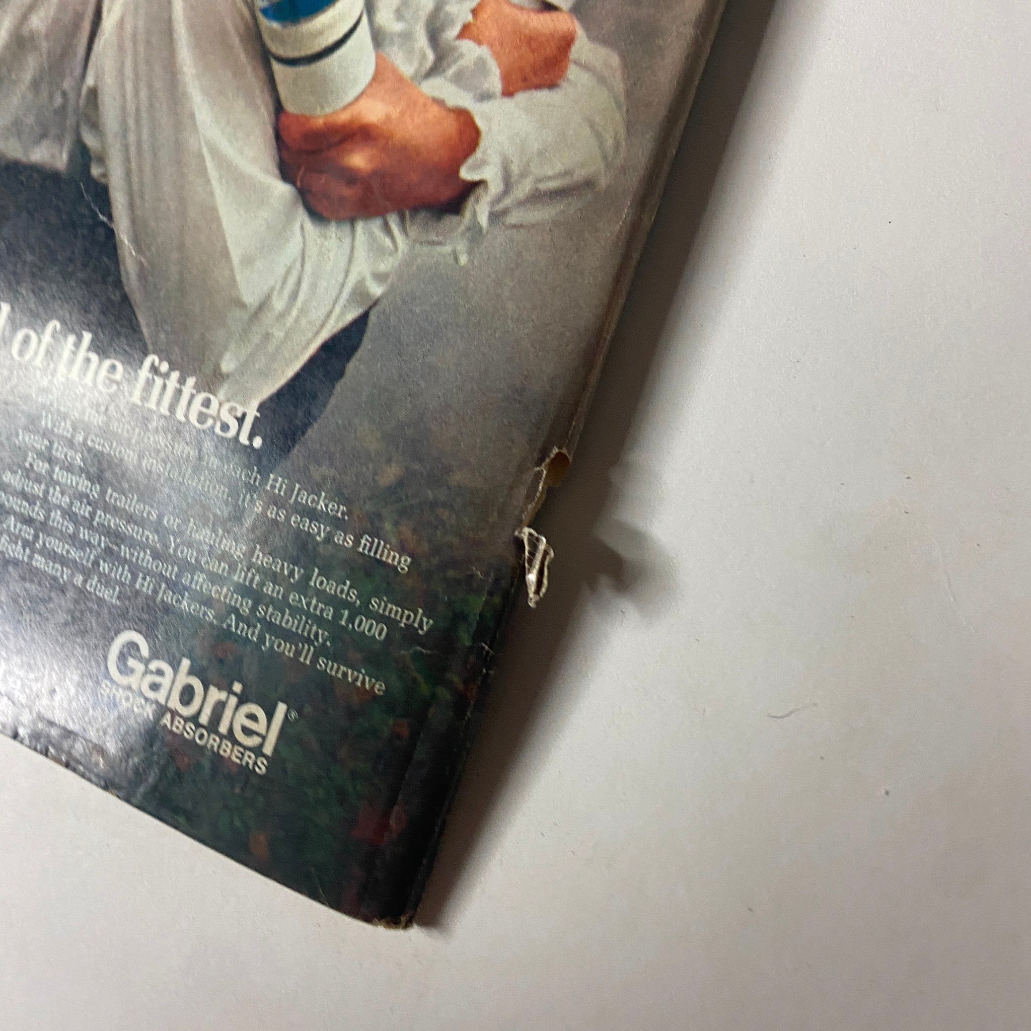 Close-up of the damaged cover of Car Craft Magazine July 1972, featuring a torn corner and creases, depicting interior wear. This edition includes the Sideplate Session and is recognized for its coverage of the 1972 Street Machine Nationals.