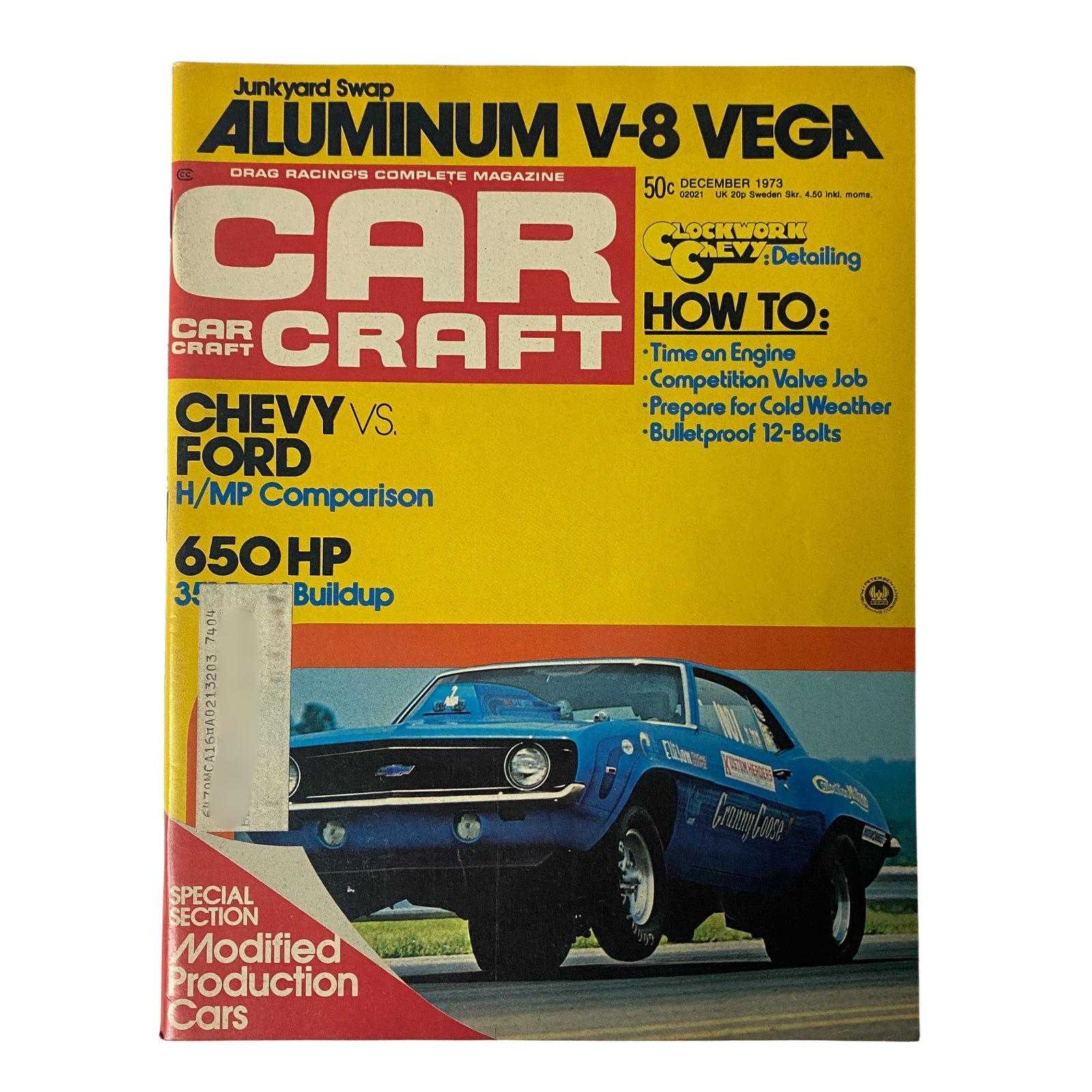 Car Craft Magazine December 1973 cover featuring Chevy vs Ford H/MP Comparison, highlighting drag racing and muscle cars, with a graphic design reflecting classic automotive culture.