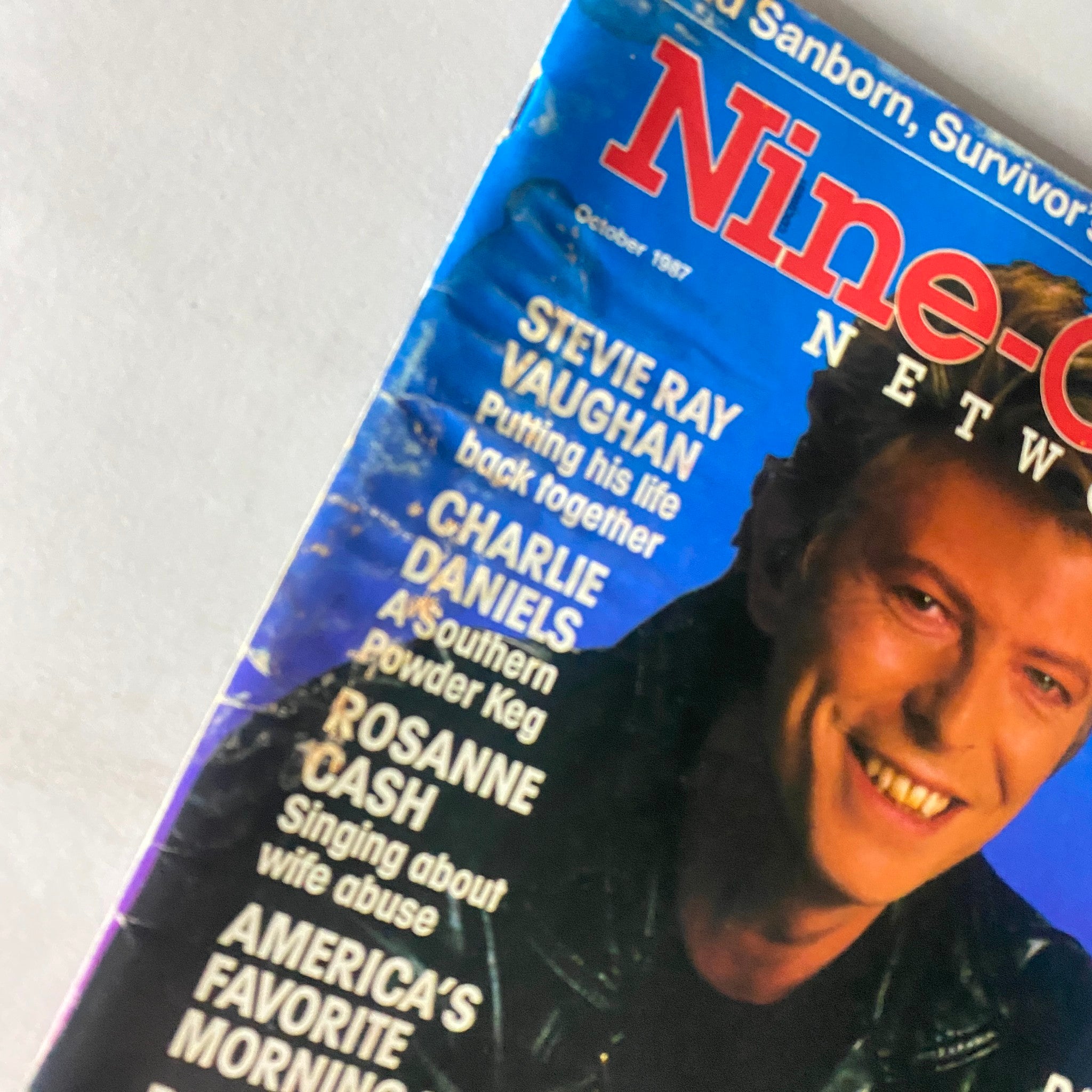 Close-up of the Nine-O-One Network Magazine cover from October 1987 showcasing David Bowie, highlighting articles featuring other popular musicians.
