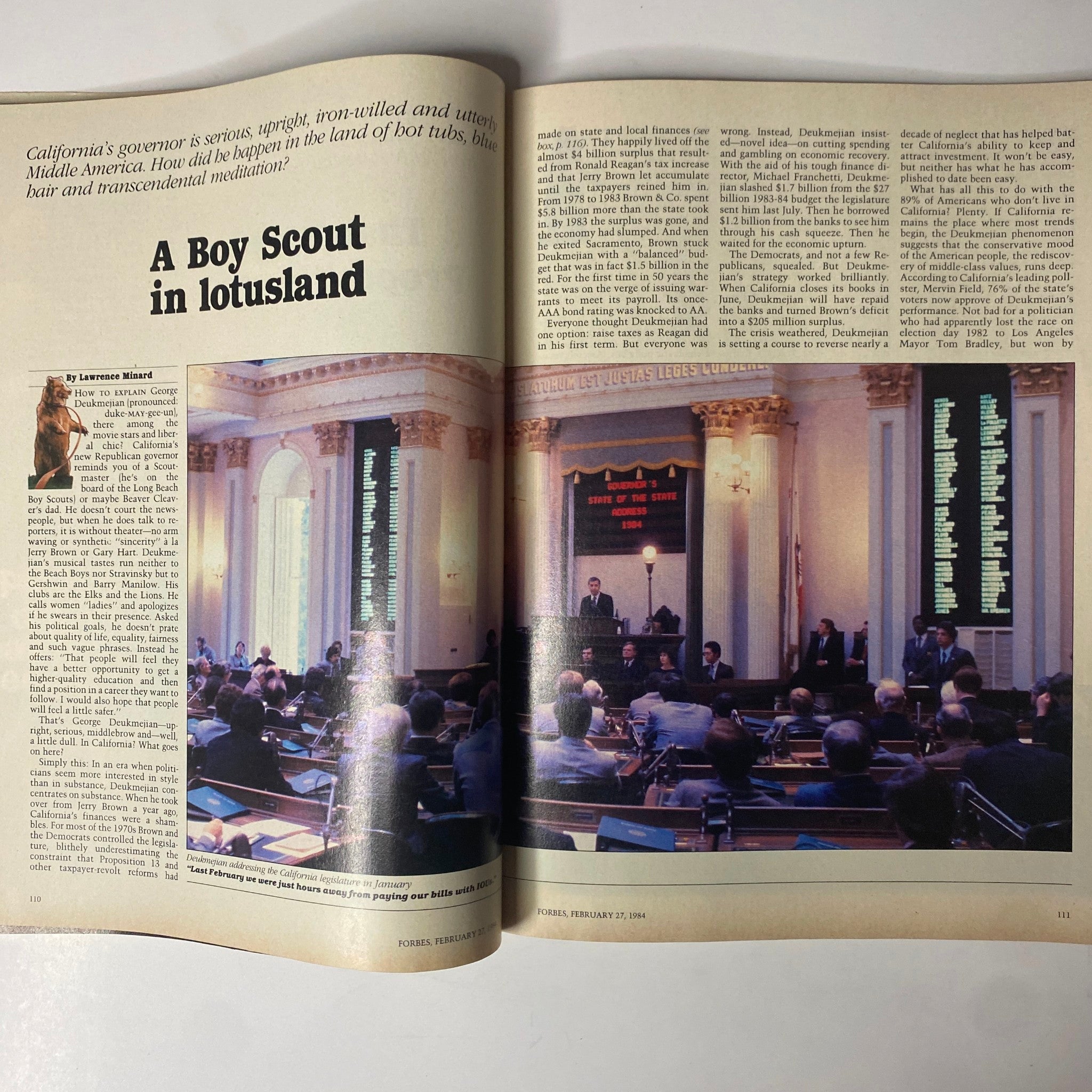 Inside page of Forbes Magazine February 27, 1984, showcasing the cover story 'A Boy Scout in Lotusland' about California Governor George Deukmejian's influence, alongside a photograph of a legislative assembly.