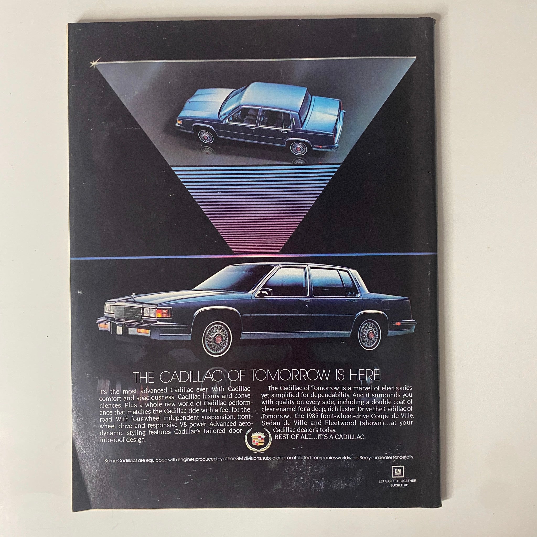 Cover image featuring the Cadillac of Tomorrow is Here advertisement from Forbes Magazine, April 23, 1984, showcasing advanced Cadillac cars with a stylish triangle design.