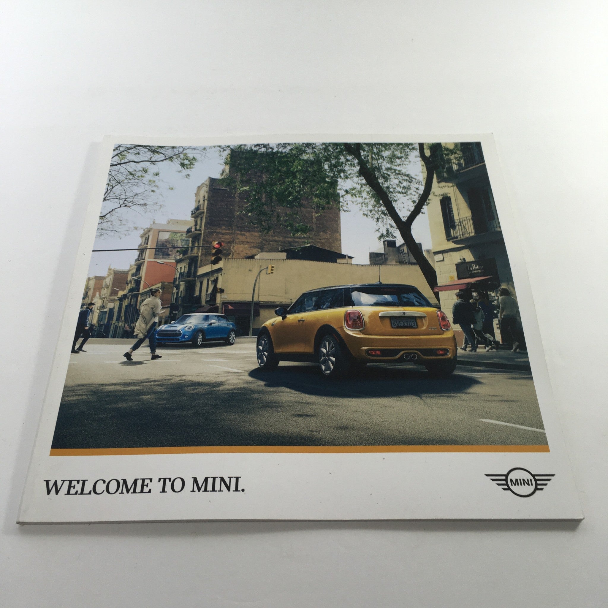 2016 Mini Cooper Motor The Spectrum Colors Dealership Car Auto Brochure Catalog cover featuring a yellow Mini in an urban setting, welcoming viewers to Mini.