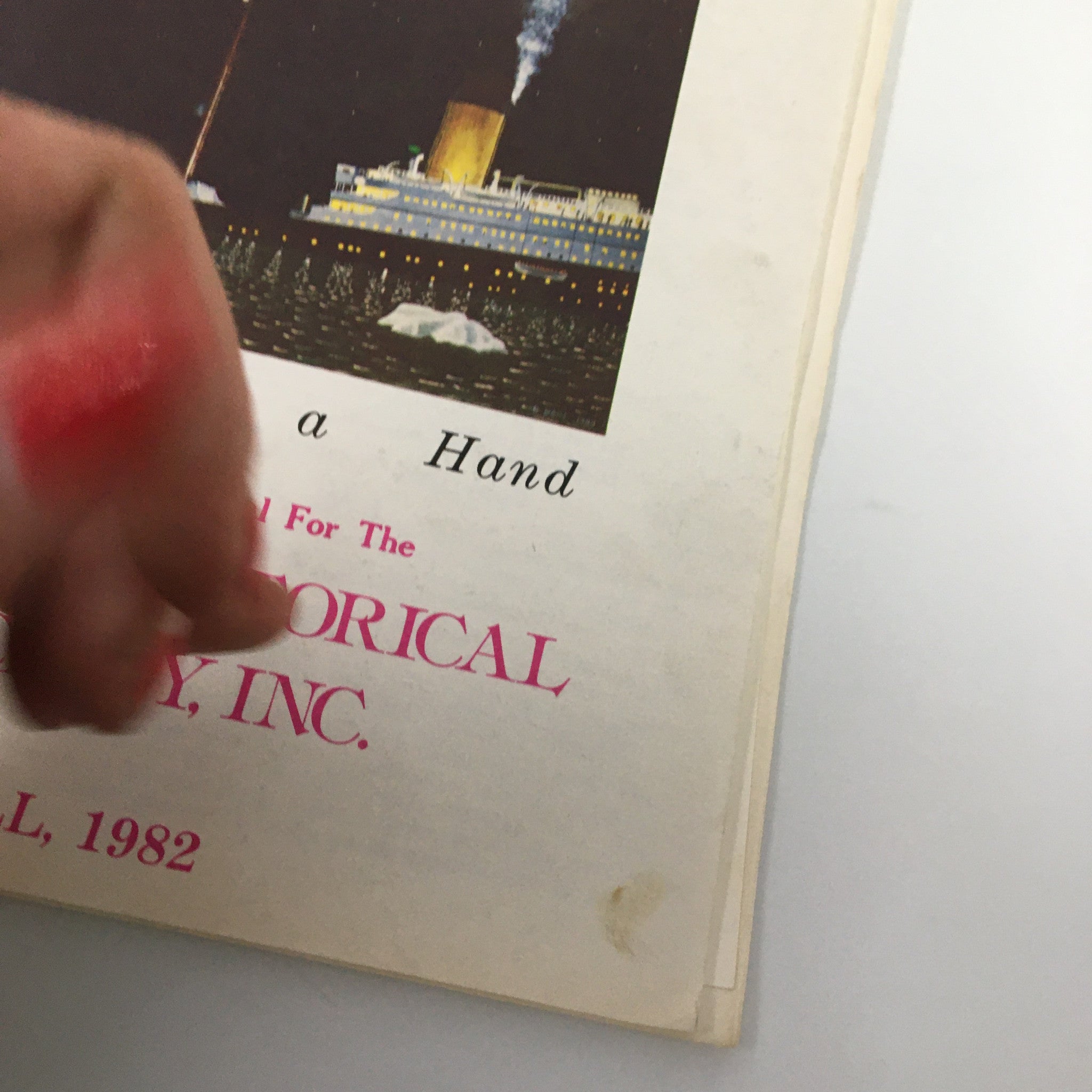Close-up view of 'The Titanic Commutator' magazine cover Fall 1982 edition titled 'Fate Deals a Hand' with hand partially covering the title.