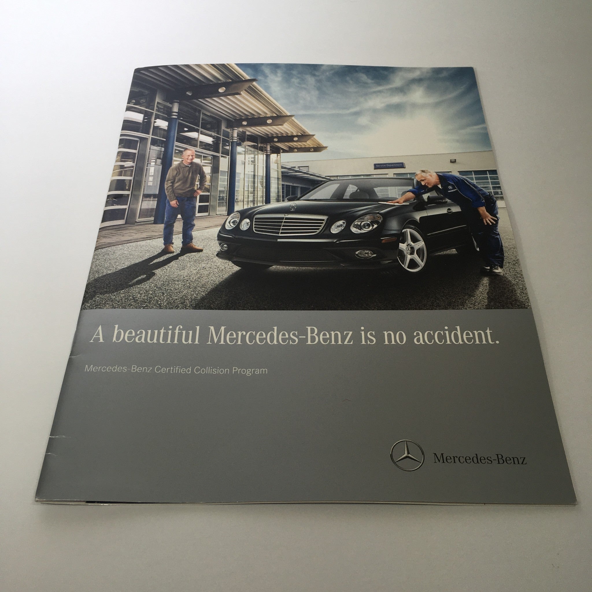 Cover of the 2012 Mercedes-Benz Application Process Certified Collision Program featuring a stylish black Mercedes-Benz vehicle and two individuals. The tagline 'A beautiful Mercedes-Benz is no accident' emphasizes the program's quality and commitment to excellence.