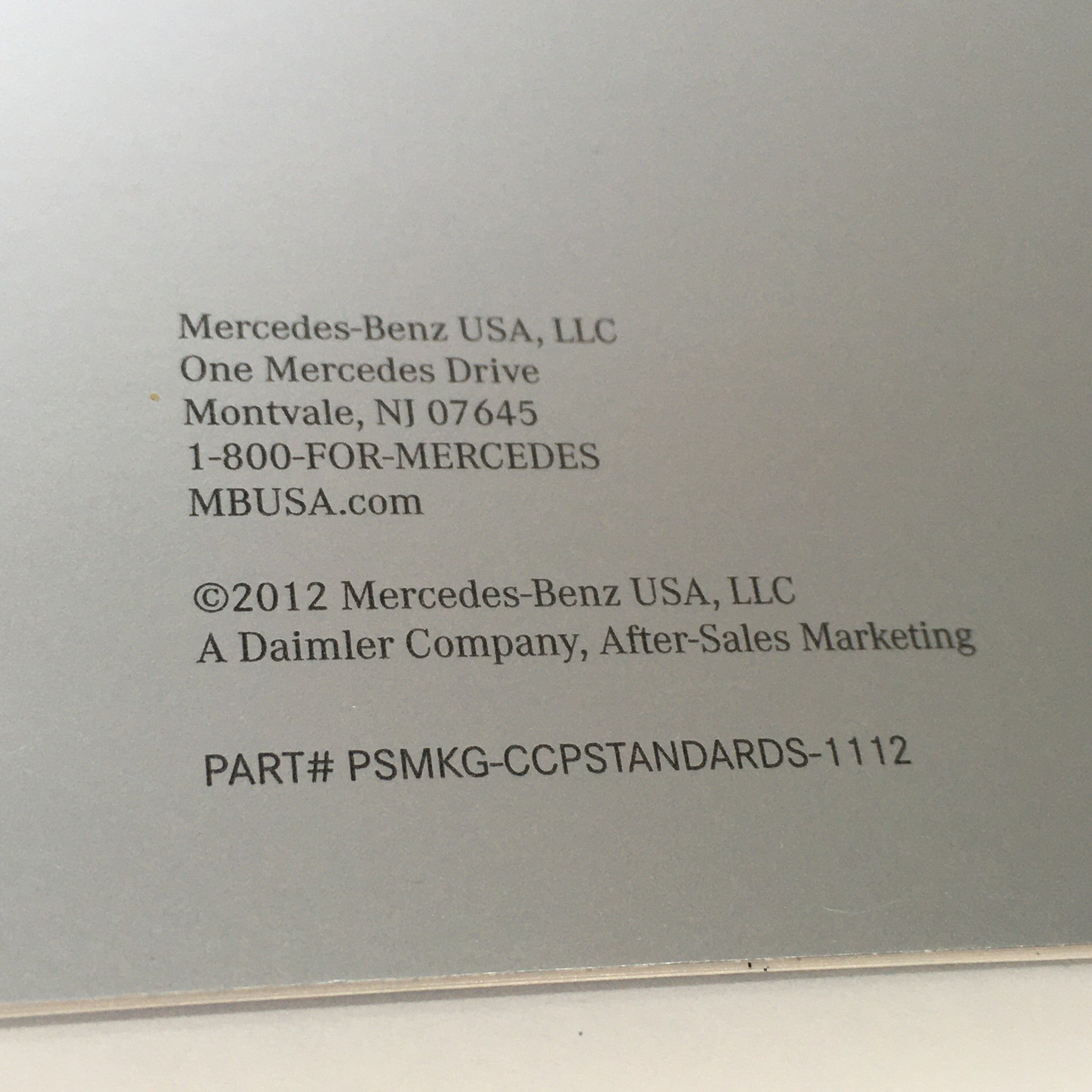 Back cover of the 2012 Mercedes-Benz Application Process Certified Collision Program showing the contact details for Mercedes-Benz USA, including the address, phone number, and part number.