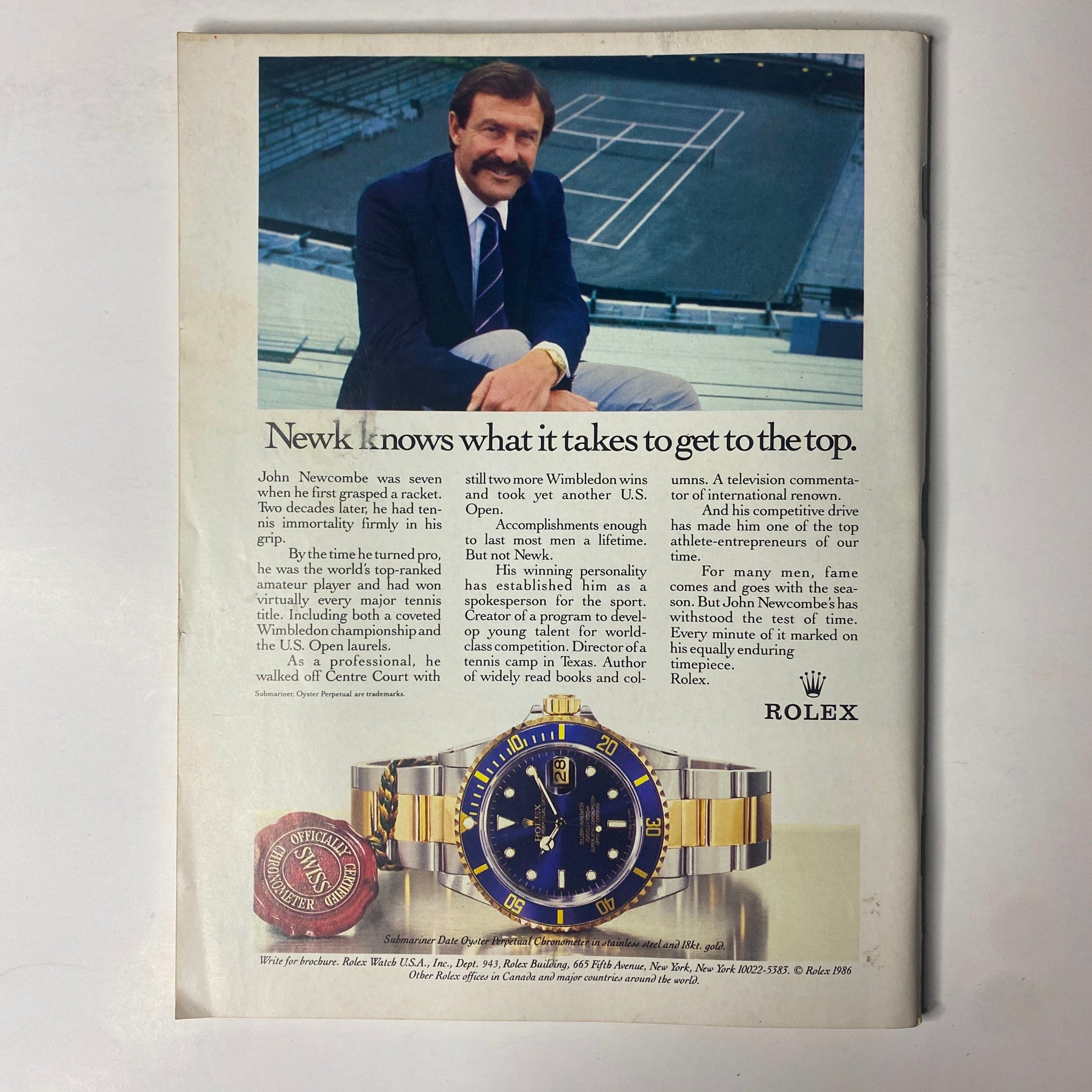 Back cover of Forbes Magazine August 25, 1986, featuring an advertisement for Rolex with a portrait of John Newcombe, a prominent tennis player.