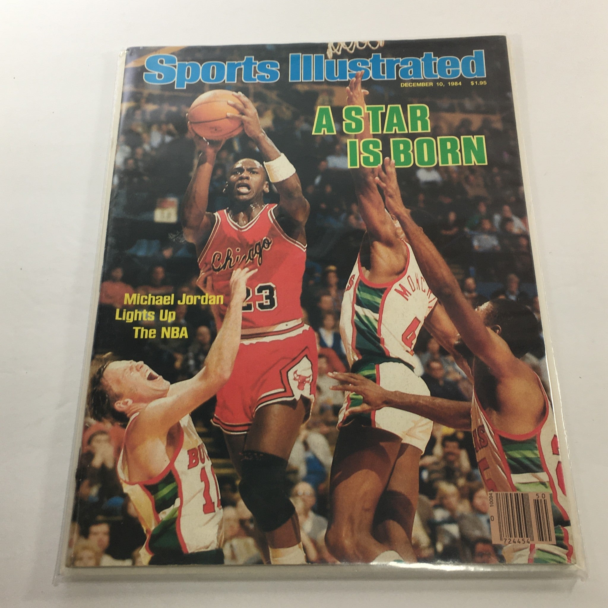 Sports Illustrated December 10, 1984 - Michael Jordan: A Star Is Born magazine cover featuring Michael Jordan in action, showcasing his basketball talent surrounded by defenders.