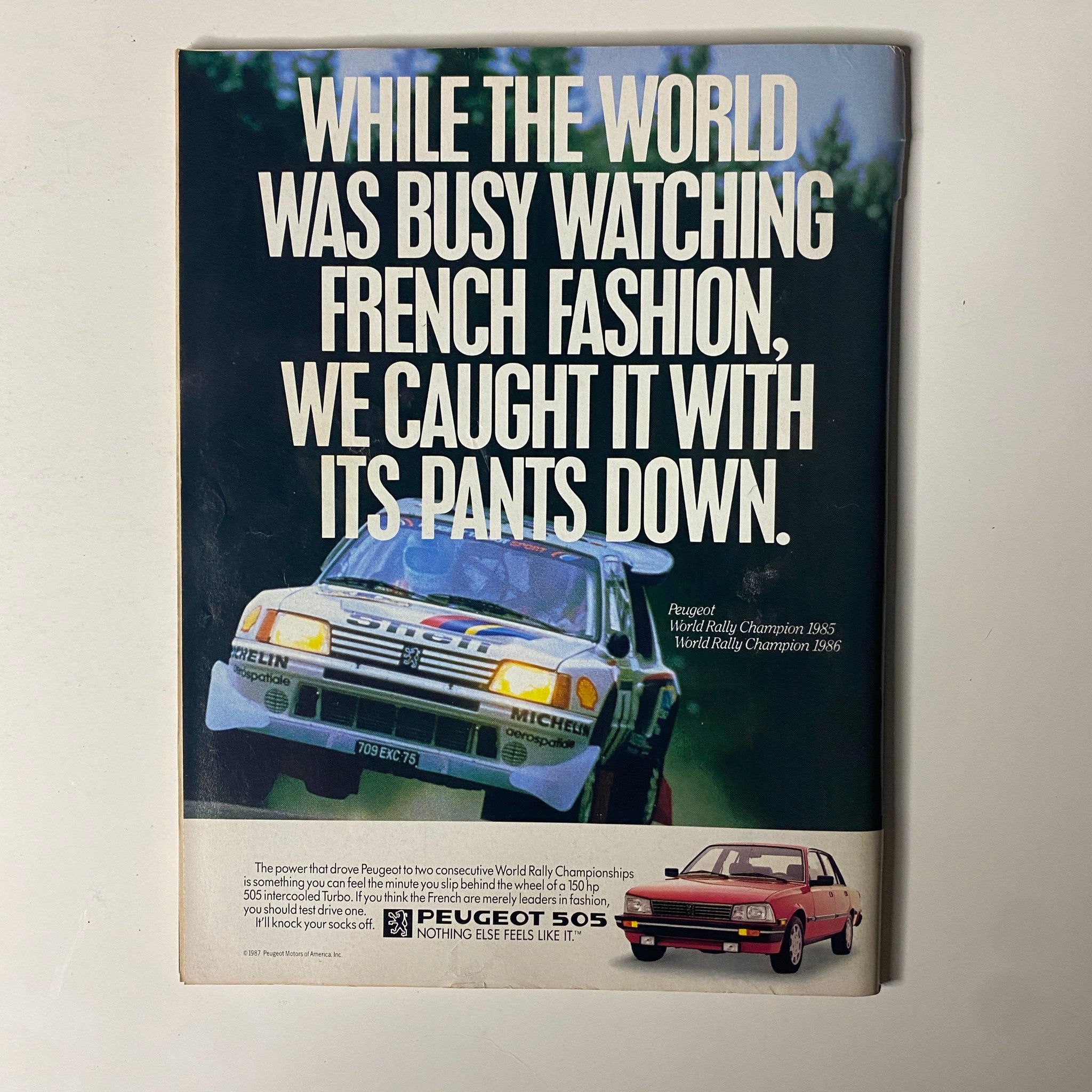 Advertisement in Forbes Magazine March 9, 1987 for Peugeot showcasing their rally championship vehicles.