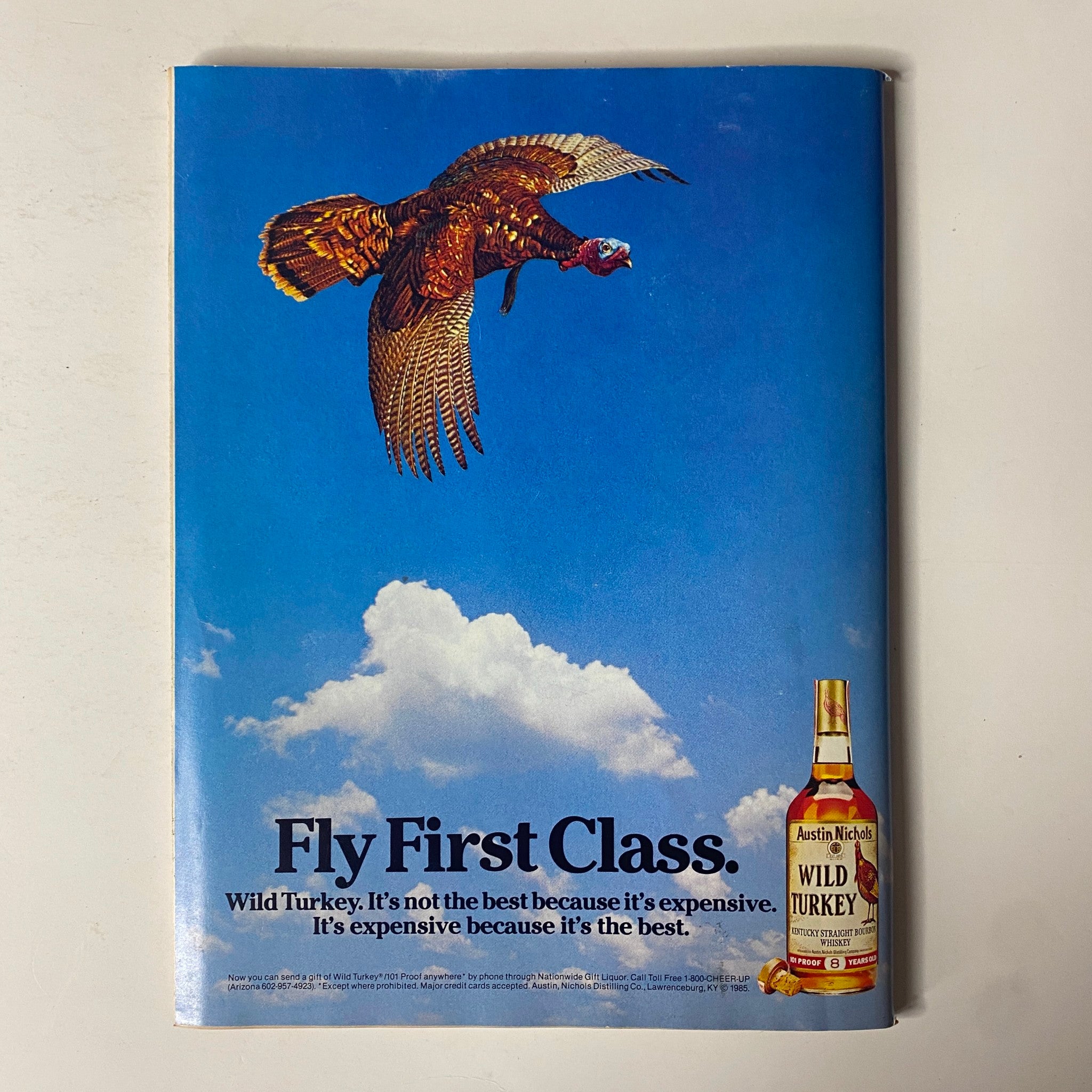 Advertisement from Forbes Magazine, October 21, 1985, promoting Wild Turkey whiskey with a striking visual of a turkey in flight.