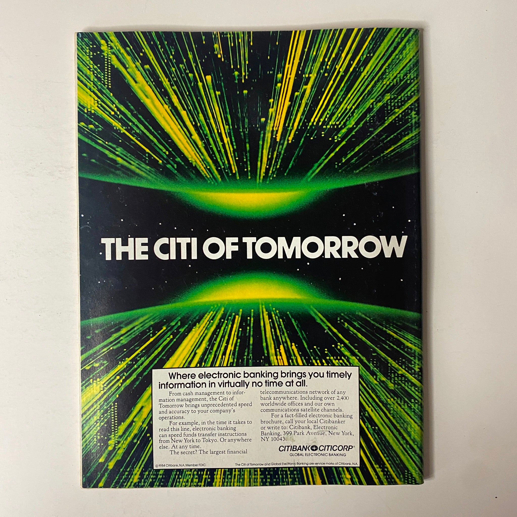 Back cover of Forbes Magazine January 30, 1984 advertising 'The Citi of Tomorrow' with a vibrant graphic design showcasing electronic banking innovations. This visually striking ad emphasizes timely financial information and modern banking solutions.